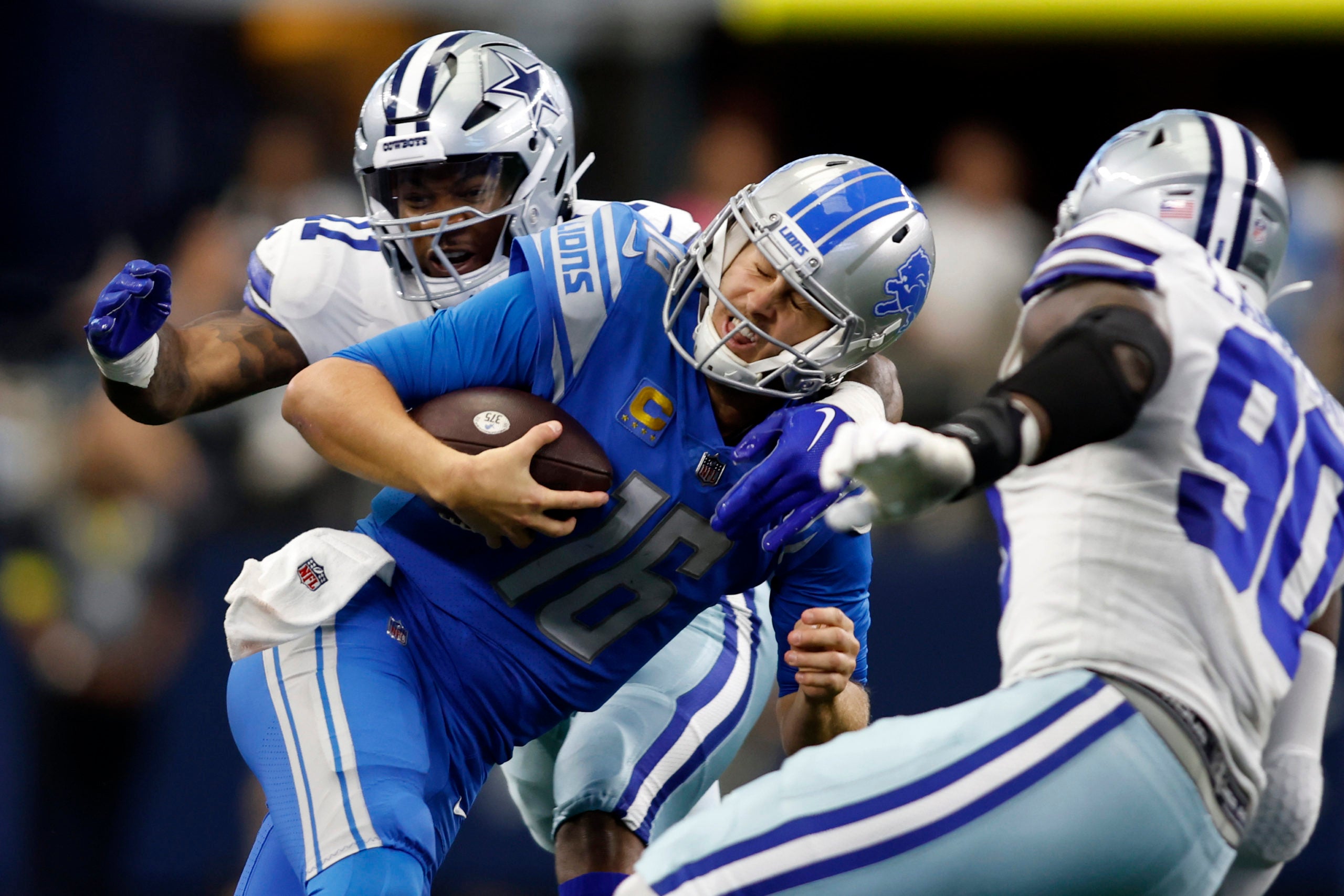 Oct 23, 2022; Arlington, Texas, USA; Detroit Lions quarterback Jared Goff (16) is tackled by Dallas Cowboys linebacker Micah Parsons (11) and defensive end DeMarcus Lawrence (90) in the third quarter at AT&T Stadium. Mandatory Credit: Tim Heitman-USA TODAY Sports
