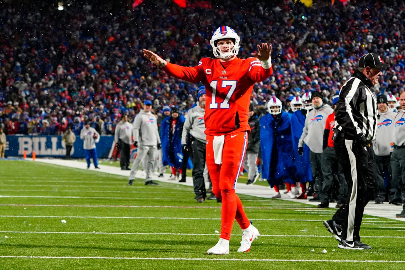 Dec 17, 2022; Orchard Park, New York, USA; Buffalo Bills quarterback Josh Allen (17) tells fans to stop throwing snowballs on the field during the second half against the Miami Dolphins at Highmark Stadium. Mandatory Credit: Gregory Fisher-USA TODAY Sports