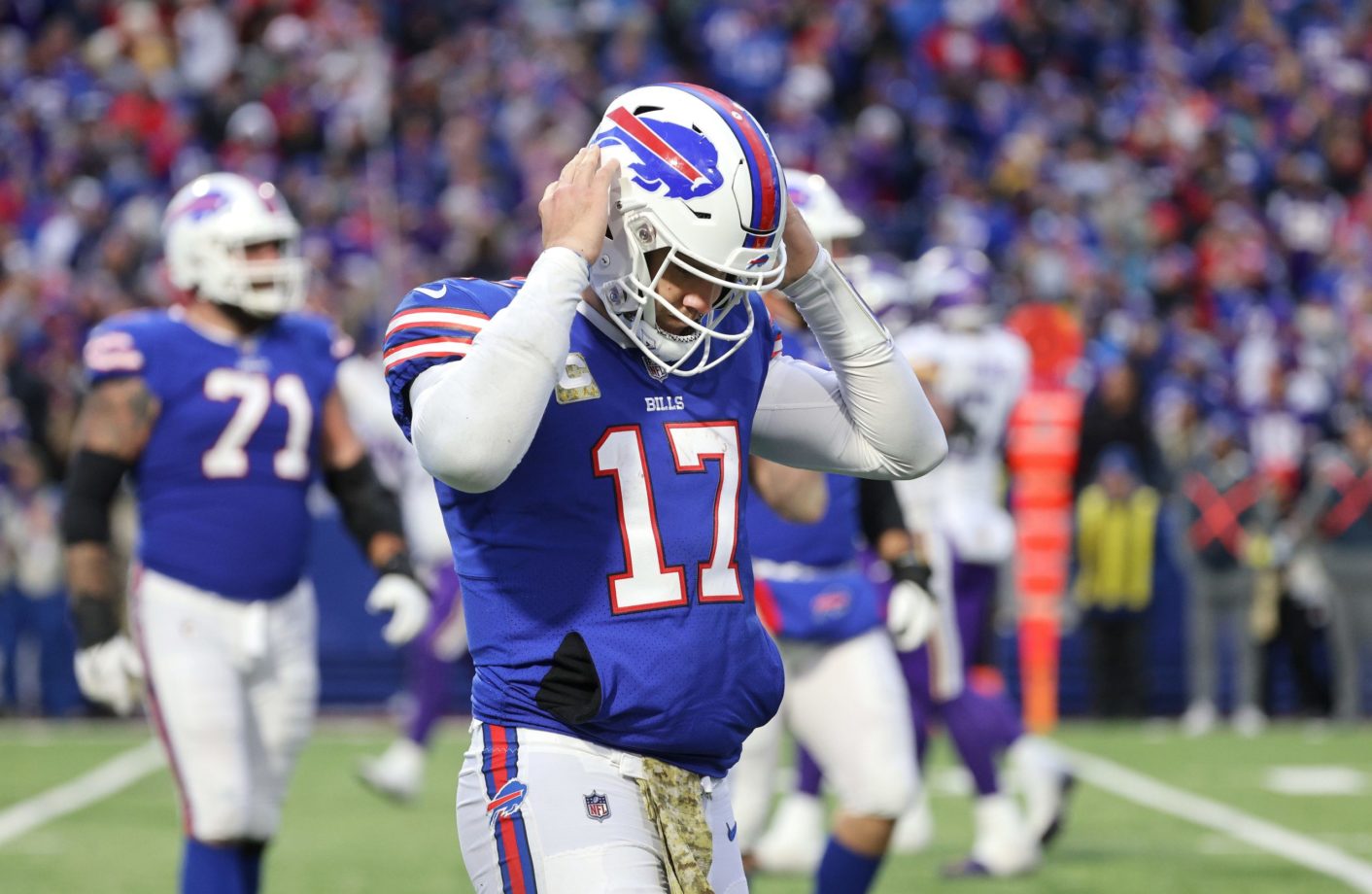Bills quarterback Josh Allen comes off the field after mishandling the snap from center that led to the Vikings go ahead touchdown late in the 4th quarter . The Bills went on to lose in overtime 33-30.