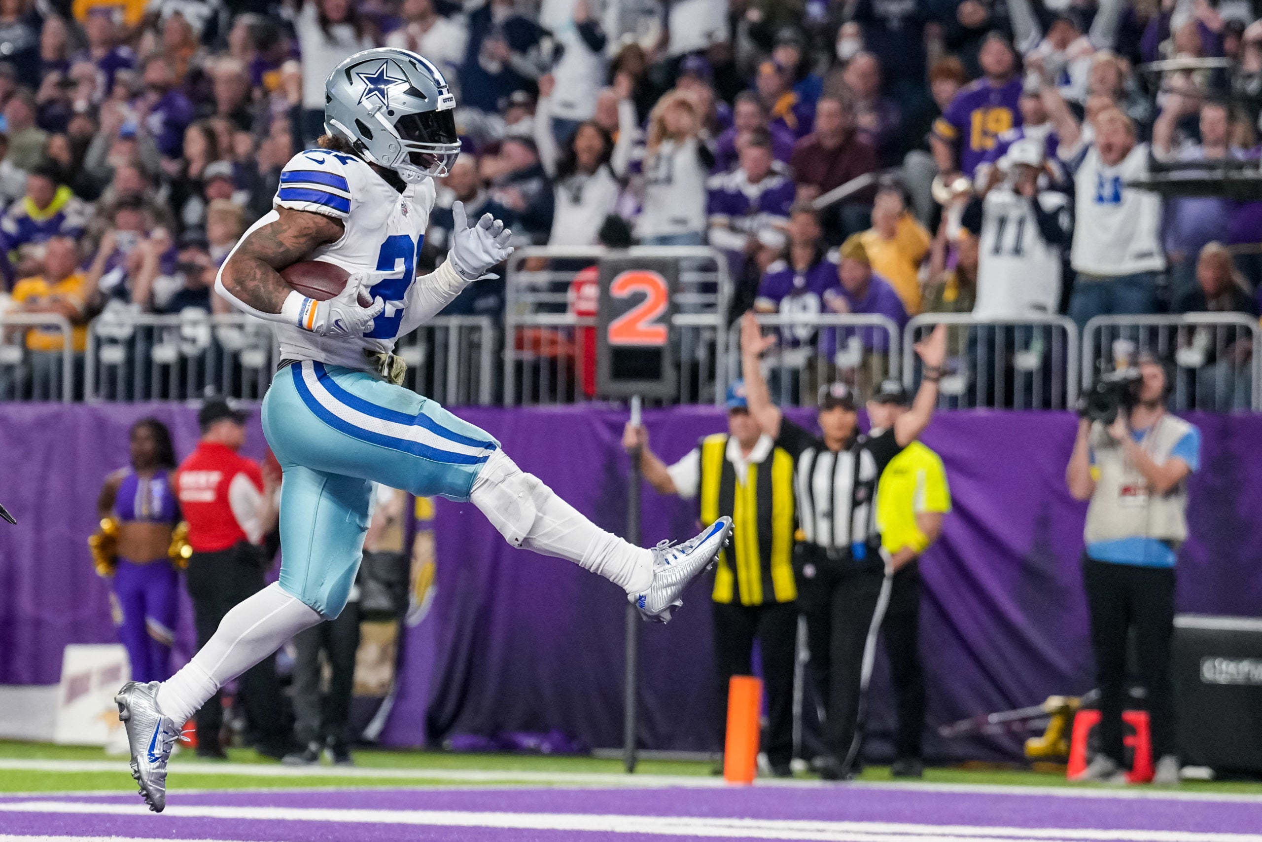 Nov 20, 2022; Minneapolis, Minnesota, USA; Dallas Cowboys running back Ezekiel Elliott (21) scores a touchdown during the third quarter against the Minnesota Vikings at U.S. Bank Stadium. Mandatory Credit: Brace Hemmelgarn-USA TODAY Sports