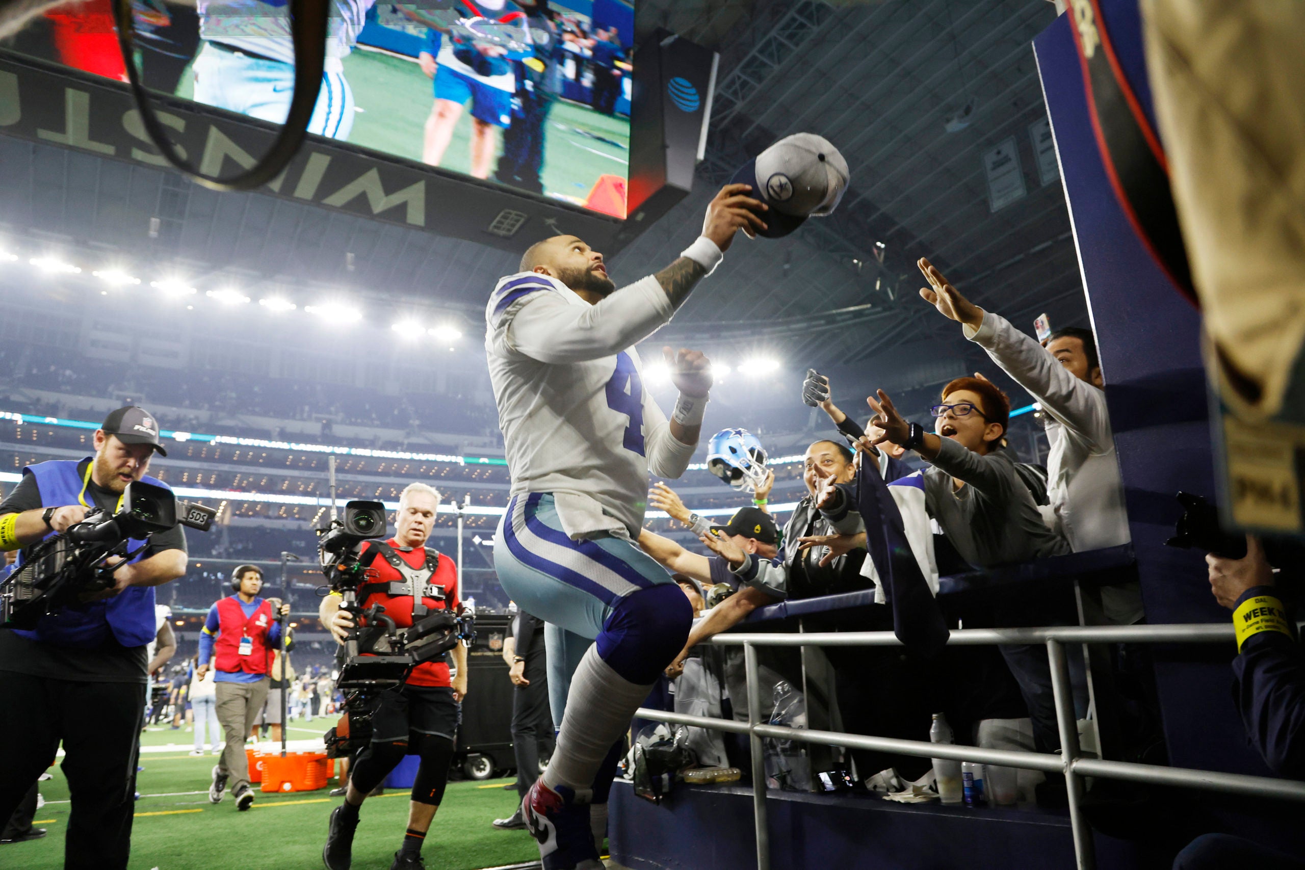 Dec 4, 2022; Arlington, Texas, USA; Dallas Cowboys quarterback Dak Prescott (4) throws his hat into the stands after the game against the Indianapolis Colts at AT&T Stadium. Mandatory Credit: Tim Heitman-USA TODAY Sports