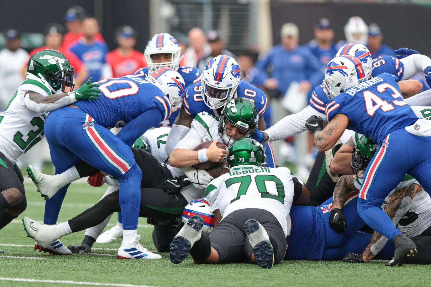 Nov 6, 2022; East Rutherford, New Jersey, USA; New York Jets quarterback Zach Wilson (2) fights for a first down as Buffalo Bills defensive end Shaq Lawson (90) tackles during the first half at MetLife Stadium. Mandatory Credit: Vincent Carchietta-USA TODAY Sports