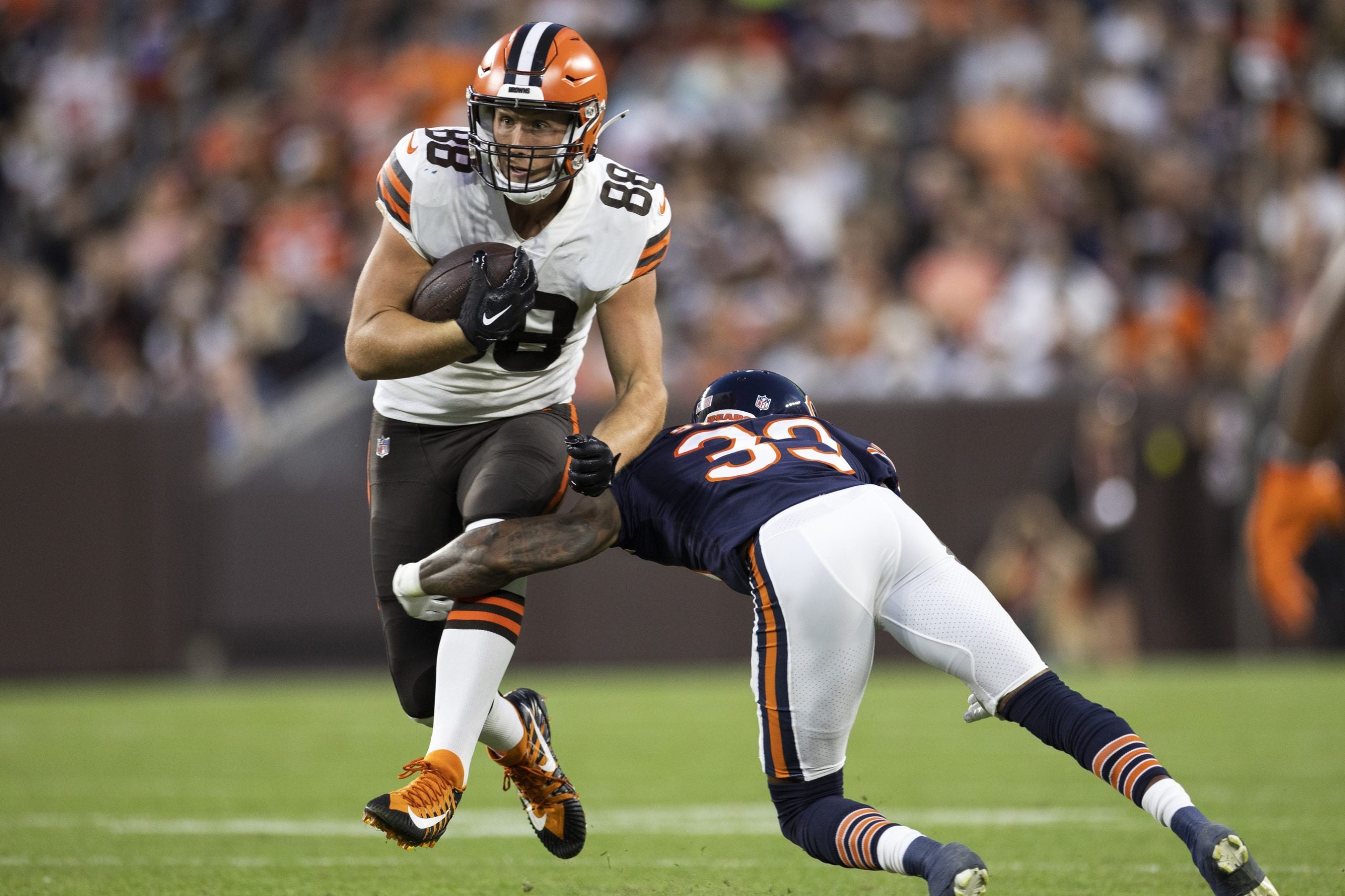 Aug 27, 2022; Cleveland, Ohio, USA; Cleveland Browns tight end Harrison Bryant (88) runs through a tackle attempt by Chicago Bears cornerback Jaylon Johnson (33) during the second quarter at FirstEnergy Stadium. Mandatory Credit: Scott Galvin-USA TODAY Sports