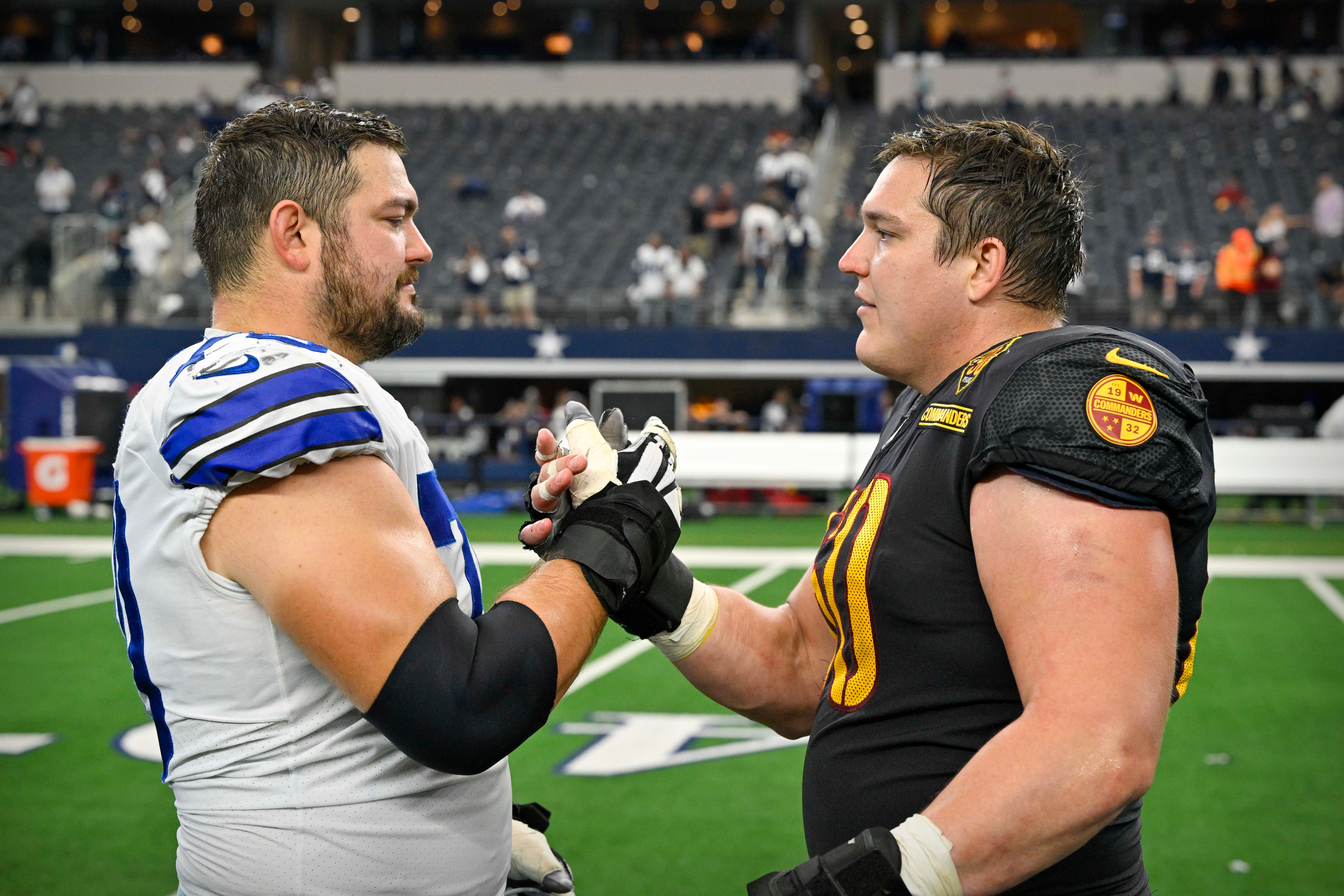 Oct 2, 2022; Arlington, Texas, USA; Dallas Cowboys guard Zack Martin (70) talks with his brother Washington Commanders center Nick Martin (60) after the game at AT&T Stadium. Mandatory Credit: Jerome Miron-USA TODAY Sports
