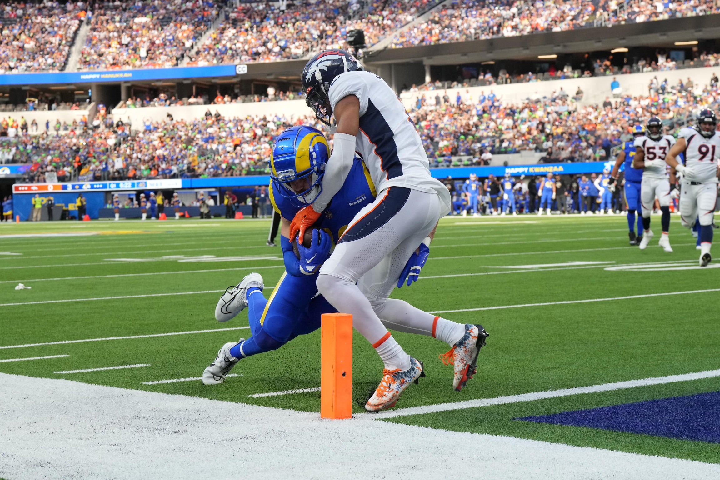 Dec 25, 2022; Inglewood, California, USA; Los Angeles Rams tight end Tyler Higbee (89) scores on a 9-yard touchdown pass against Denver Broncos cornerback Pat Surtain II (2) in the first half at SoFi Stadium. Mandatory Credit: Kirby Lee-USA TODAY Sports