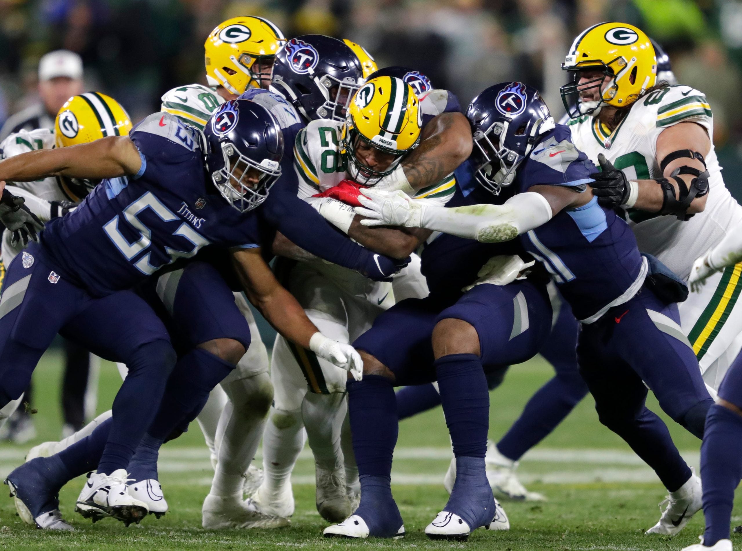 Green Bay Packers running back AJ Dillon (28) is stopped by the Tennessee Titans defense during their football game Thursday, November 17, at Lambeau Field in Green Bay, Wis. Dan Powers/USA TODAY NETWORK-Wisconsin Apc Packvstitans 1117221034djp