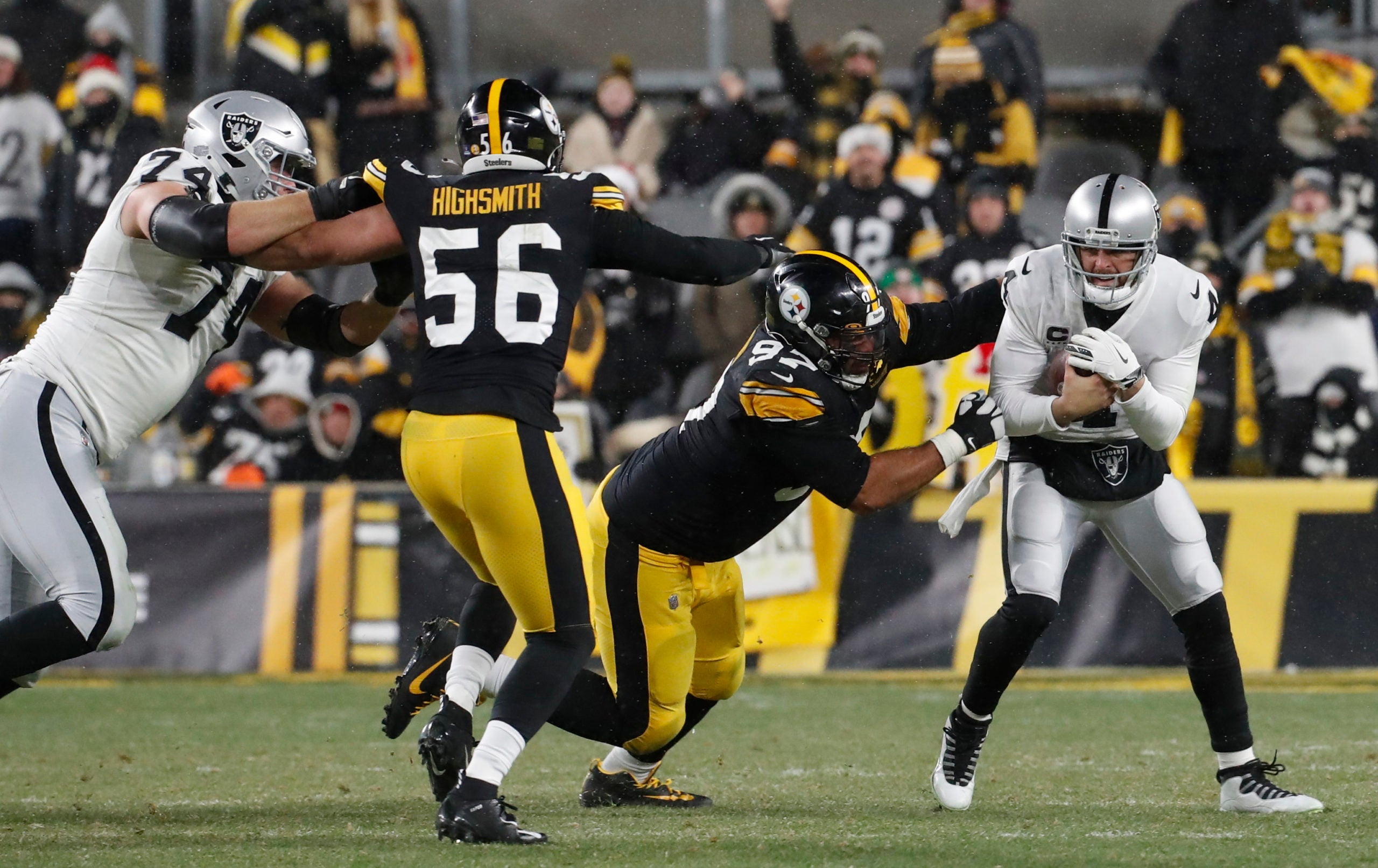 Dec 24, 2022; Pittsburgh, Pennsylvania, USA;  Pittsburgh Steelers defensive tackle Cameron Heyward (97) sacks Las Vegas Raiders quarterback Derek Carr (4) during the fourth quarter at Acrisure Stadium. The Steelers won 13-10. Mandatory Credit: Charles LeClaire-USA TODAY Sports