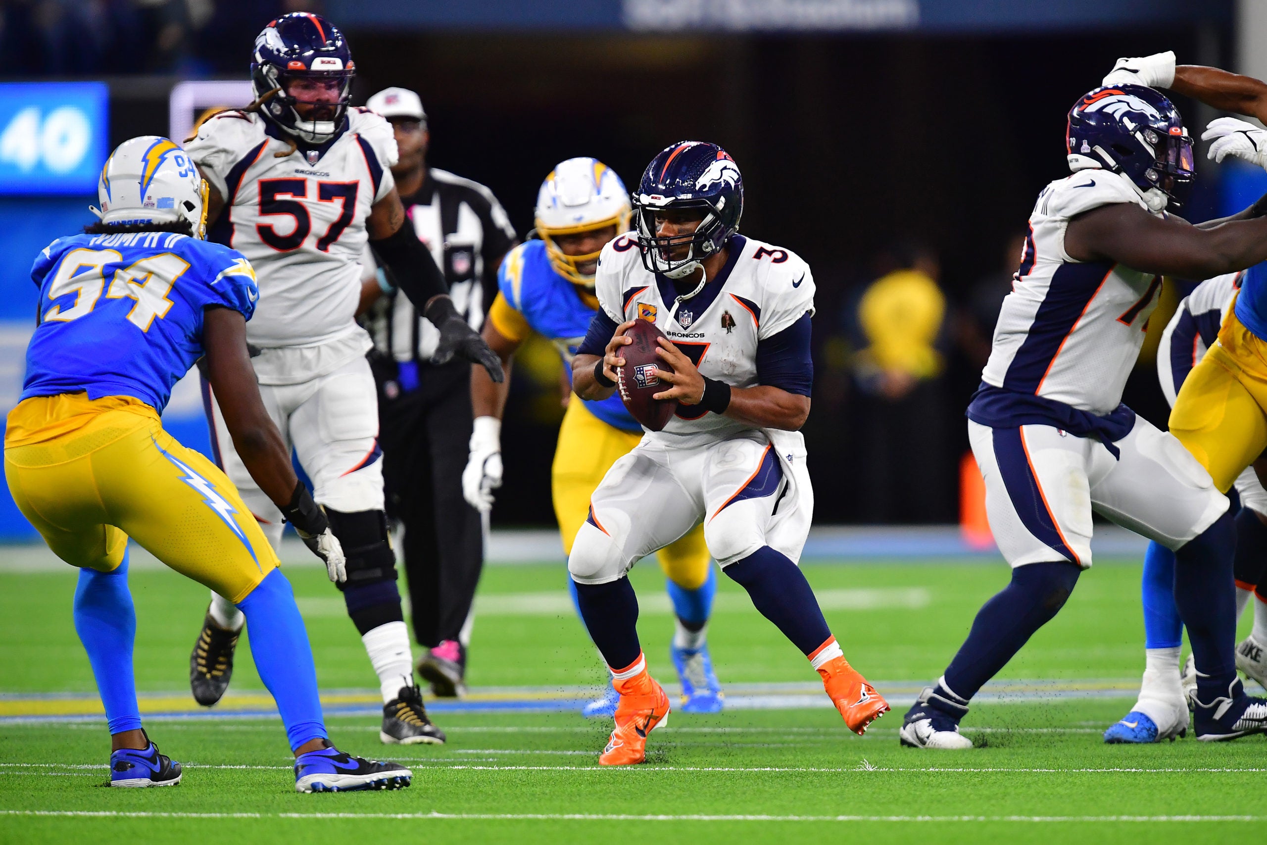 Oct 17, 2022; Inglewood, California, USA; Denver Broncos quarterback Russell Wilson (3) runs the ball against the Los Angeles Chargers during the second half at SoFi Stadium. Mandatory Credit: Gary A. Vasquez-USA TODAY Sports