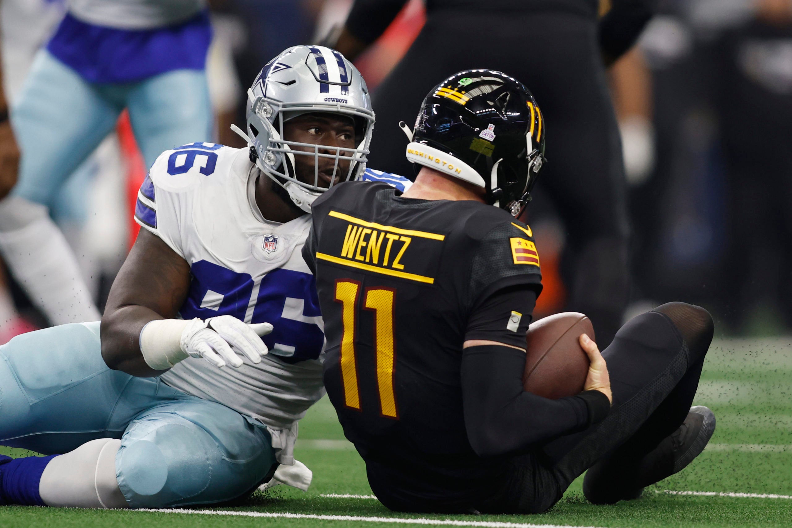 Oct 2, 2022; Arlington, Texas, USA; Dallas Cowboys defensive tackle Neville Gallimore (96) sacks Washington Commanders quarterback Carson Wentz (11) in the first quarter at AT&T Stadium. Mandatory Credit: Tim Heitman-USA TODAY Sports