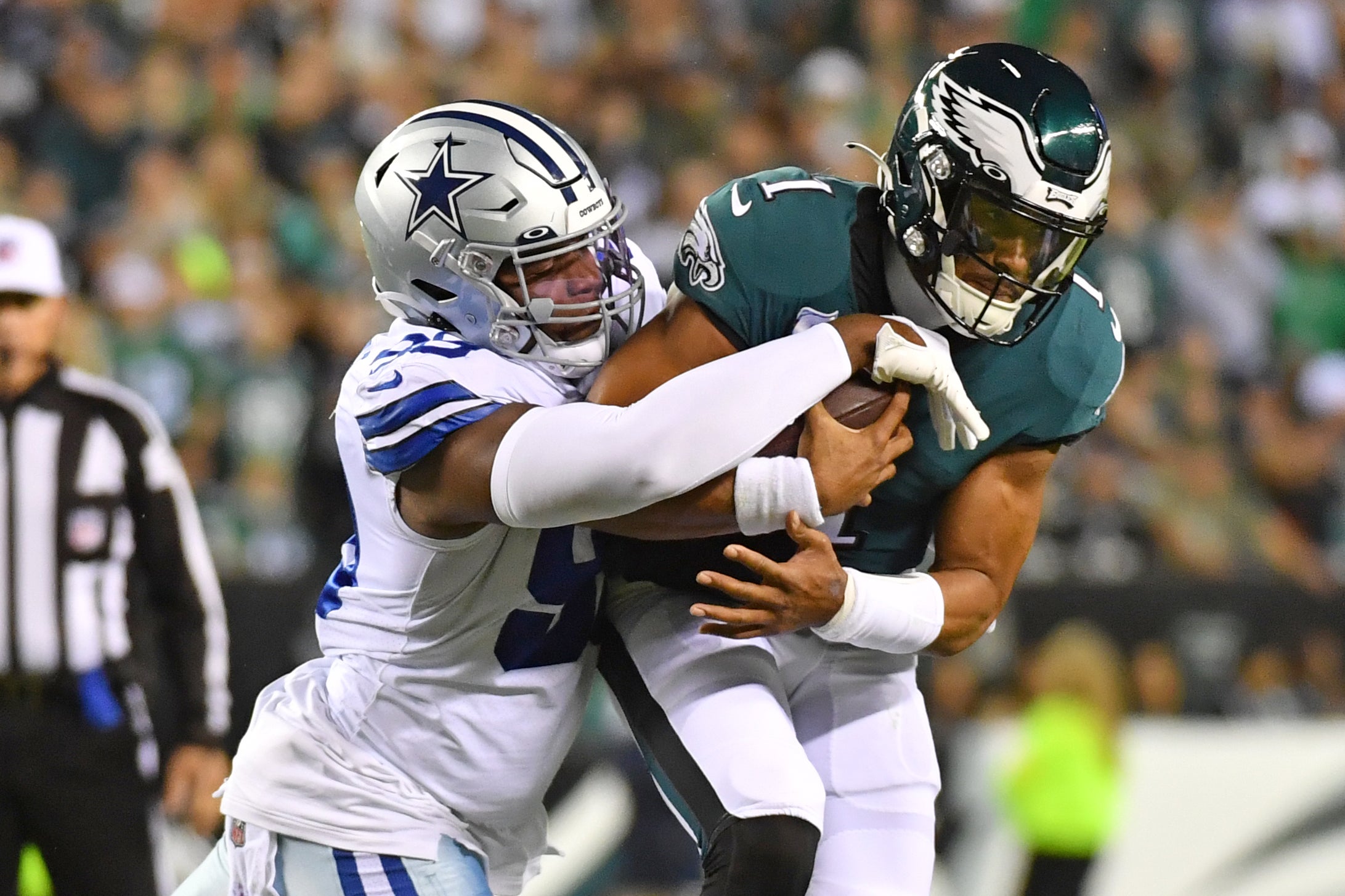 Oct 16, 2022; Philadelphia, Pennsylvania, USA; Philadelphia Eagles quarterback Jalen Hurts (1) is sacked by Dallas Cowboys defensive end Chauncey Golston (99) during the first quarter at Lincoln Financial Field. Mandatory Credit: Eric Hartline-USA TODAY Sports