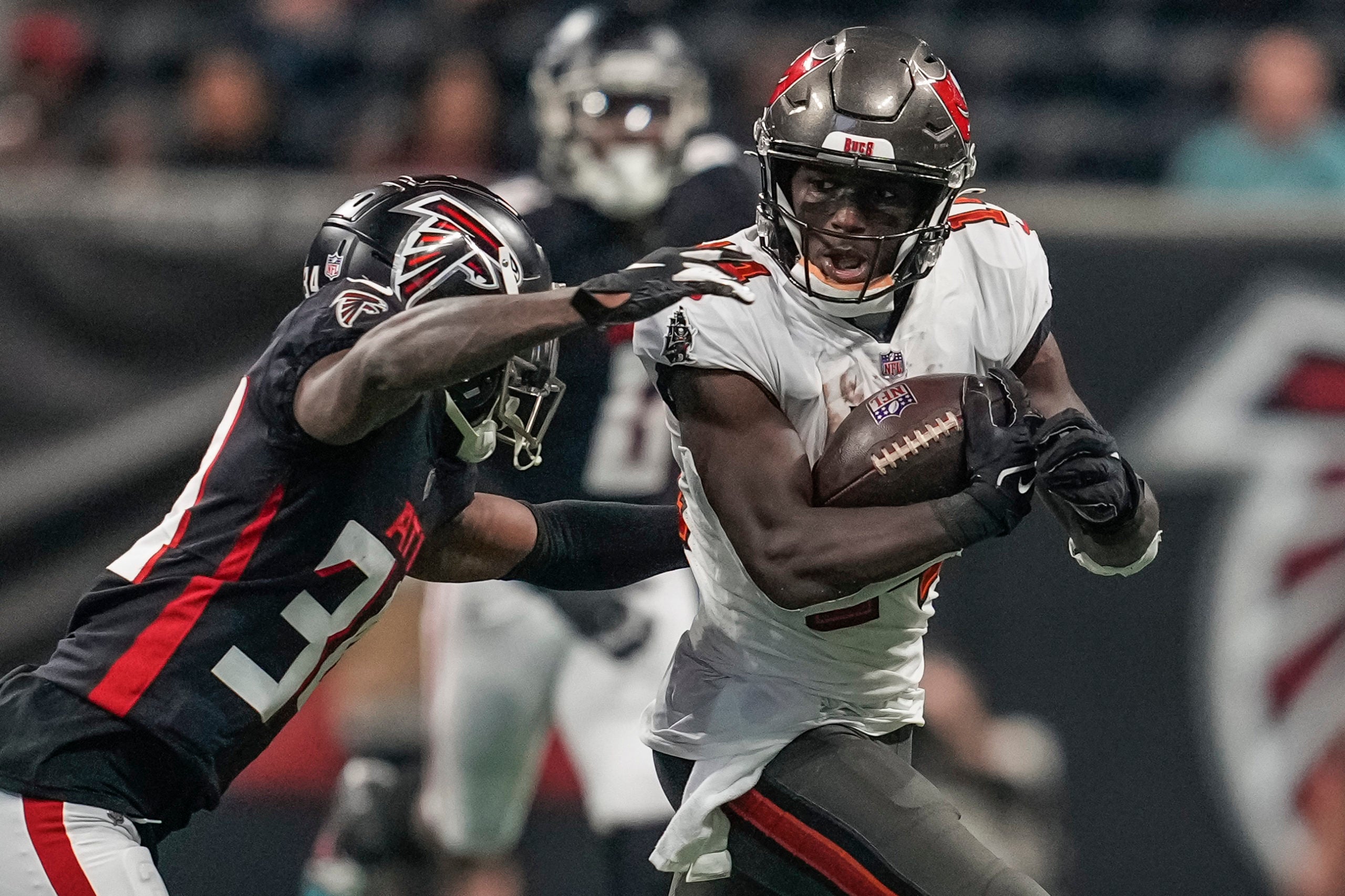 Dec 5, 2021; Atlanta, Georgia, USA; Tampa Bay Buccaneers wide receiver Chris Godwin (14) runs against Atlanta Falcons cornerback Darren Hall (34) during the first half at Mercedes-Benz Stadium. Mandatory Credit: Dale Zanine-USA TODAY Sports