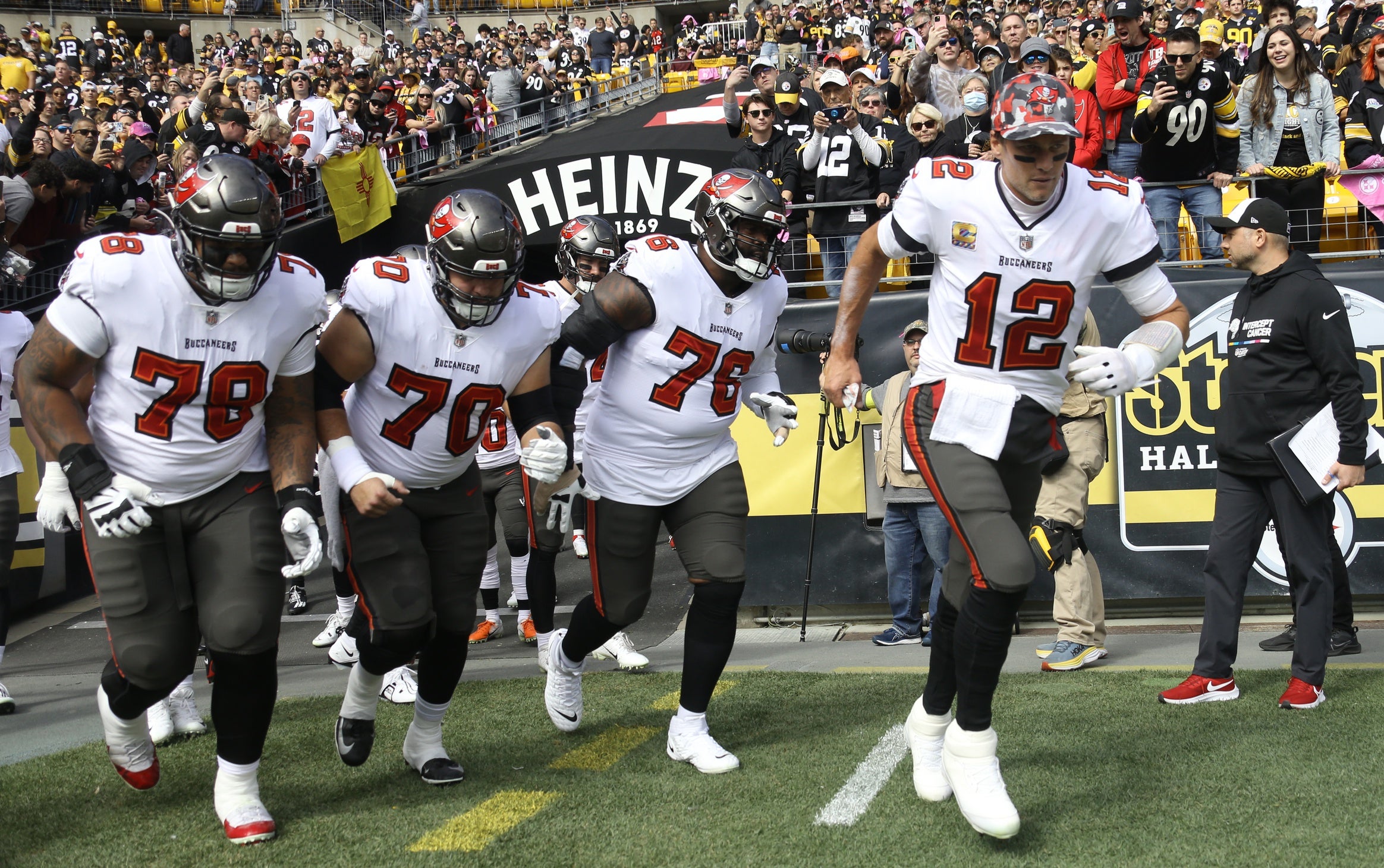 Oct 16, 2022; Pittsburgh, Pennsylvania, USA;  Tampa Bay Buccaneers quarterback Tom Brady (12) and offensive tackle Tristan Wirfs (78) and offensive tackle Robert Hainsey (70) and offensive tackle Donovan Smith (76) take the field to play the Pittsburgh Steelers at Acrisure Stadium. Mandatory Credit: Charles LeClaire-USA TODAY Sports