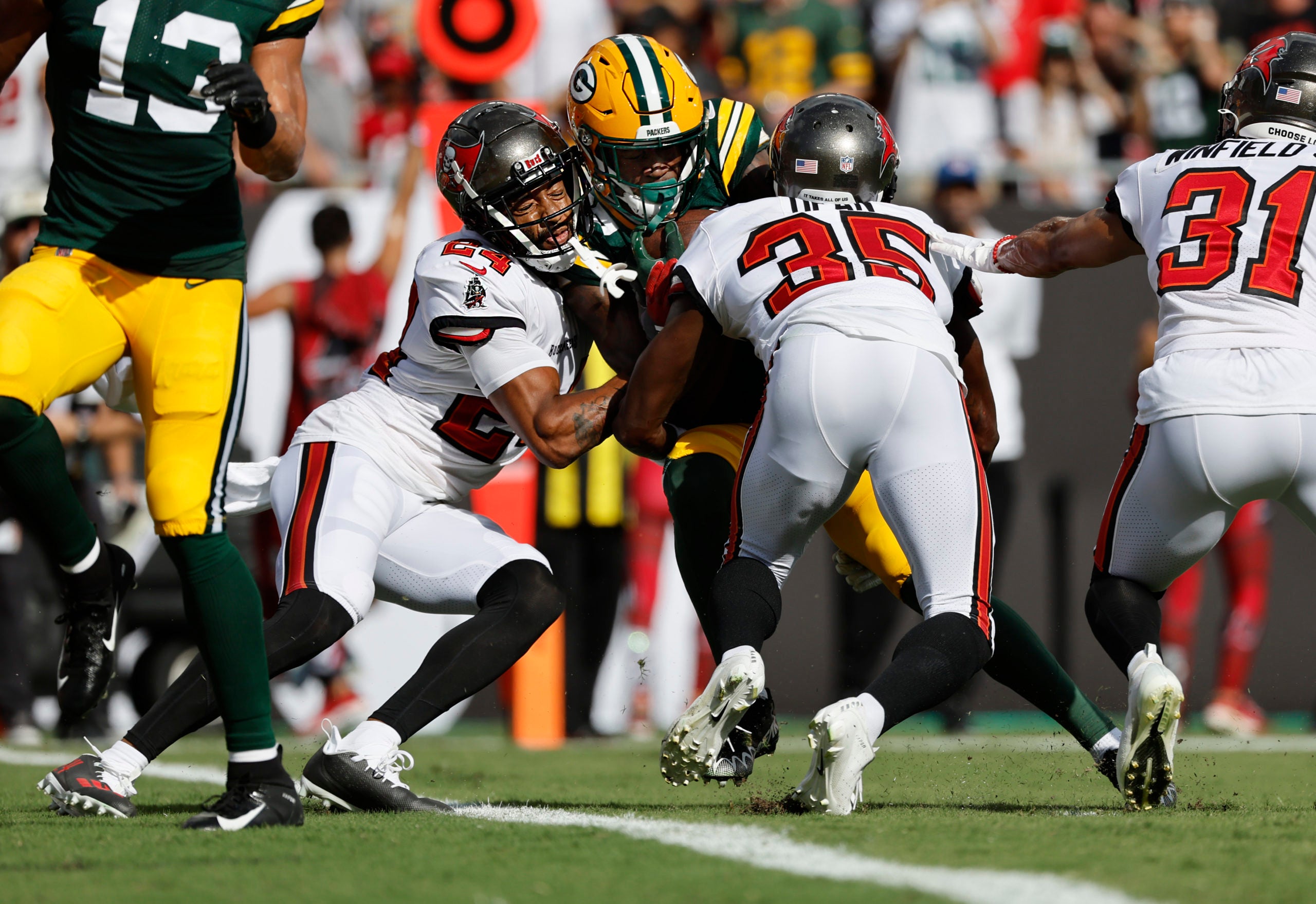 Sep 25, 2022; Tampa, Florida, USA; Green Bay Packers wide receiver Romeo Doubs (87) scores a touchdown as Tampa Bay Buccaneers cornerback Carlton Davis III (24) and cornerback Jamel Dean (35) defend during the first quarter at Raymond James Stadium. Mandatory Credit: Kim Klement-USA TODAY Sports