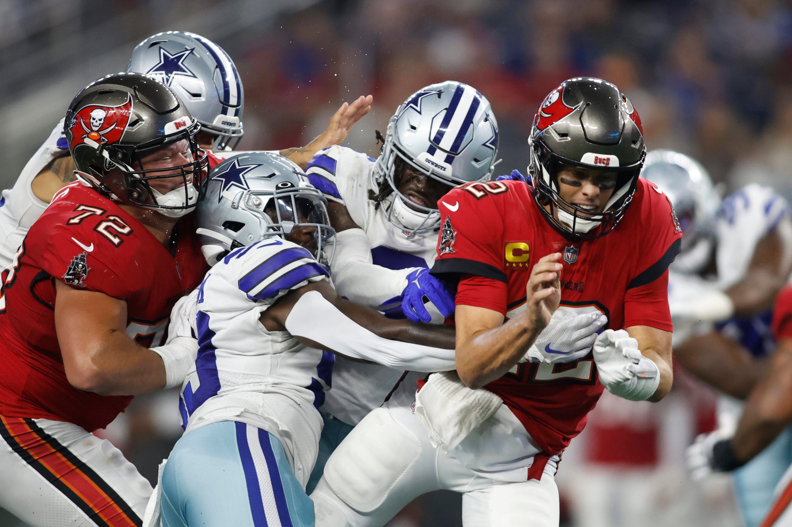 Sep 11, 2022; Arlington, Texas, USA; Dallas Cowboys defensive end Tarell Basham (93) hits Tampa Bay Buccaneers quarterback Tom Brady (12) after he throws a pass in the fourth quarter at AT&T Stadium. Mandatory Credit: Tim Heitman-USA TODAY Sports