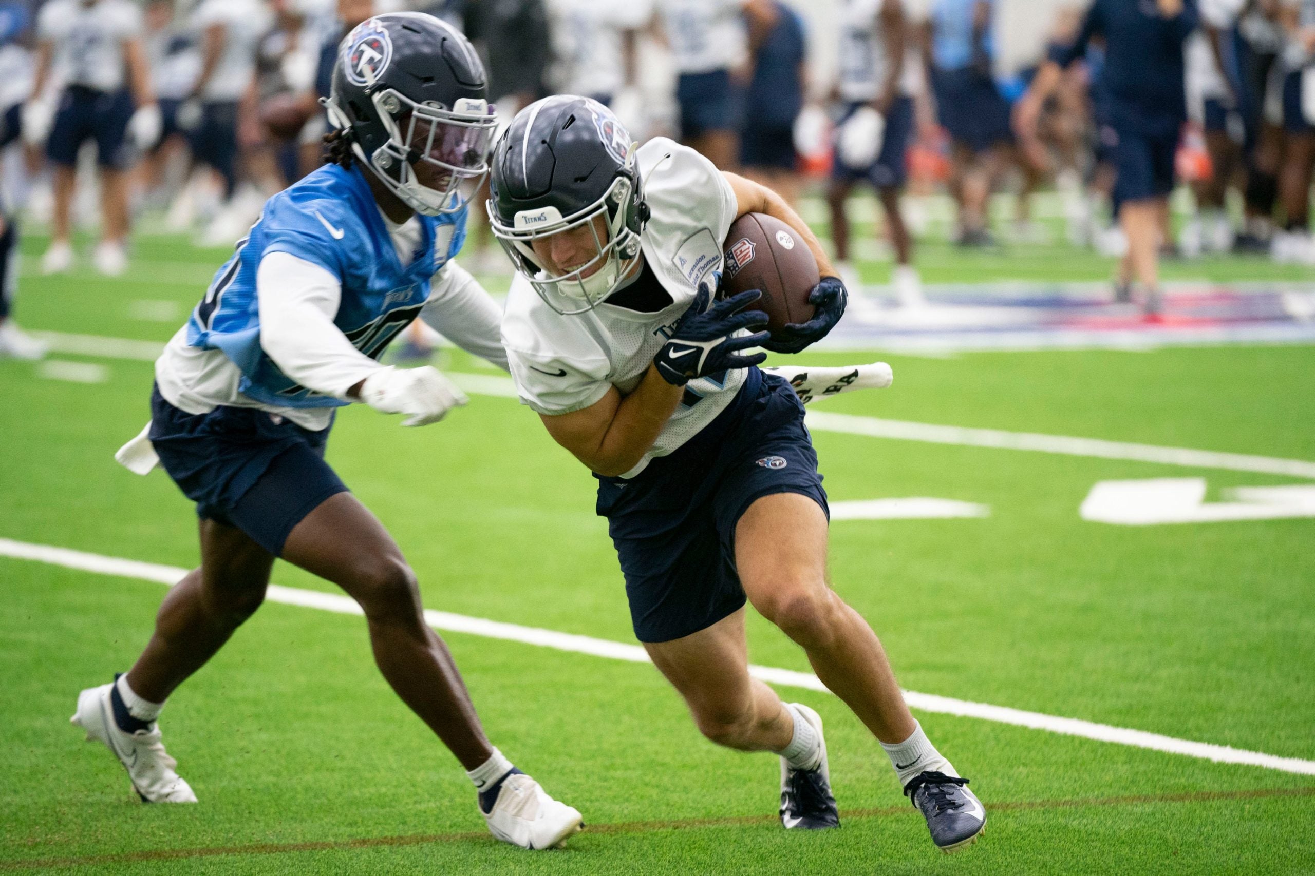 Tennessee Titans wide receiver Kyle Phillips (18) races past cornerback Kenneth George Jr. (40) after making a catch during a training camp practice at Saint Thomas Sports Park Friday, July 29, 2022, in Nashville, Tenn. Nas 0729 Titans 004