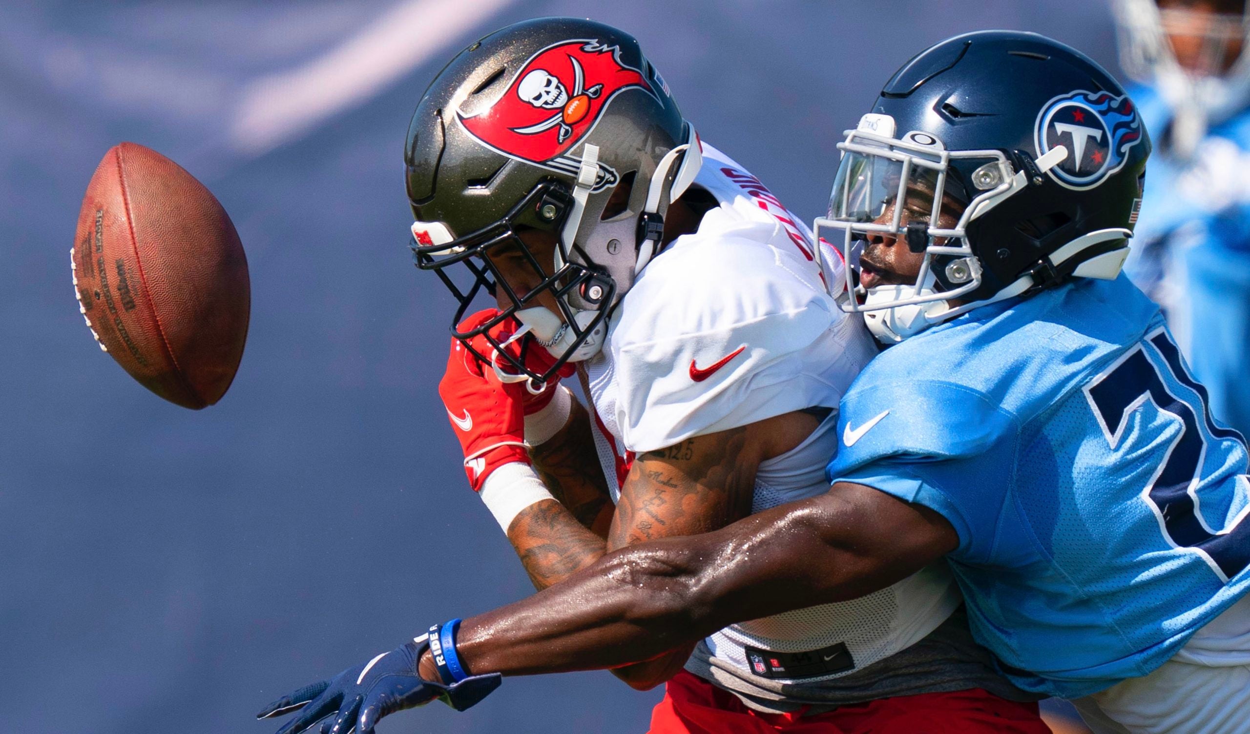 Aug 18, 2022; Nashville, Tennessee; Tennessee Titans cornerback Roger McCreary (21) breaks up a pass intended for Tampa Bay Buccaneers wide receiver Jerreth Sterns (9) during a joint training camp practice at Ascension Saint Thomas Sports Park. Mandatory Credit: George Walker IV-USA TODAY Sports
