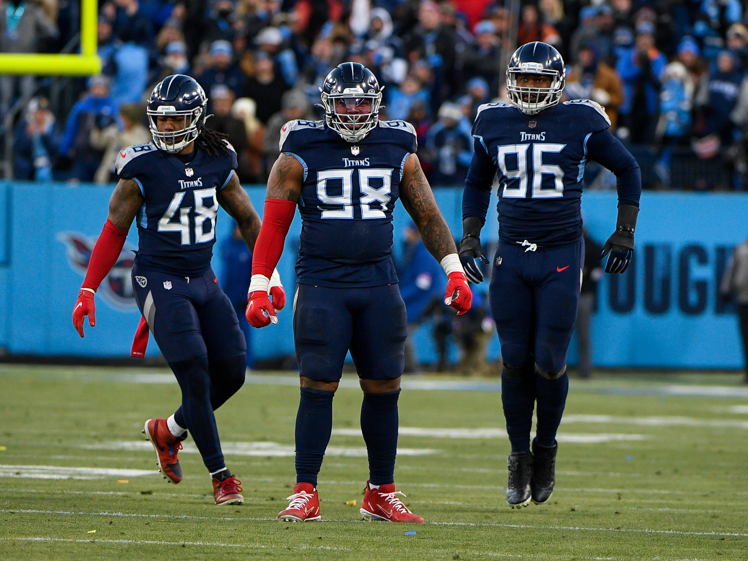 Jan 22, 2022; Nashville, Tennessee, USA; Tennessee Titans defensive tackle Jeffery Simmons (98) celebrates his sack with outside linebacker Bud Dupree (48) and defensive end Denico Autry (96) against the Cincinnati Bengals during the second half during a AFC Divisional playoff football game at Nissan Stadium. Mandatory Credit: Steve Roberts-USA TODAY Sports