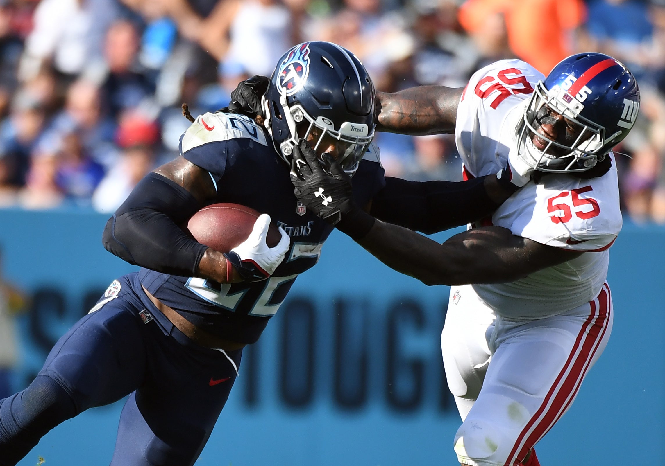 Sep 11, 2022; Nashville, Tennessee, USA; Tennessee Titans running back Derrick Henry (22) tries to fight off a tackle from New York Giants linebacker Jihad Ward (55) during the first half at Nissan Stadium. Mandatory Credit: Christopher Hanewinckel-USA TODAY Sports