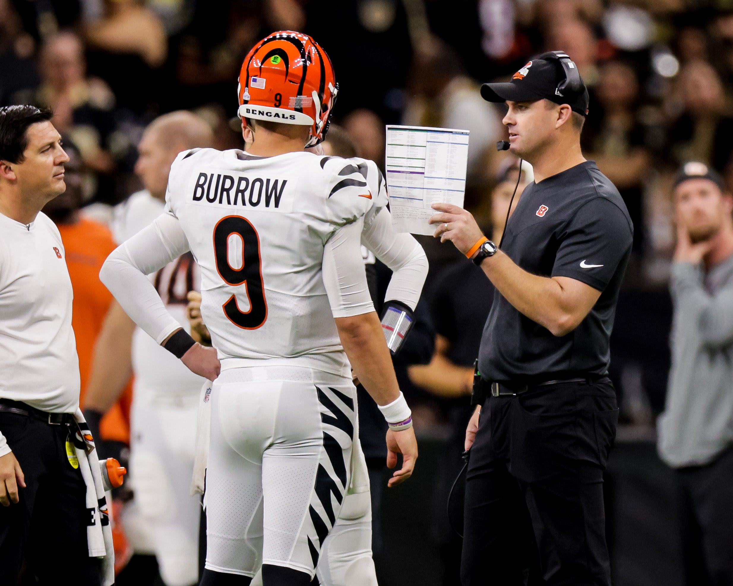 Oct 16, 2022; New Orleans, Louisiana, USA;  Cincinnati Bengals head coach Zac Taylor gives some instructions to quarterback Joe Burrow (9) during a time out against the New Orleans Saints during the second half at Caesars Superdome. Mandatory Credit: Stephen Lew-USA TODAY Sports