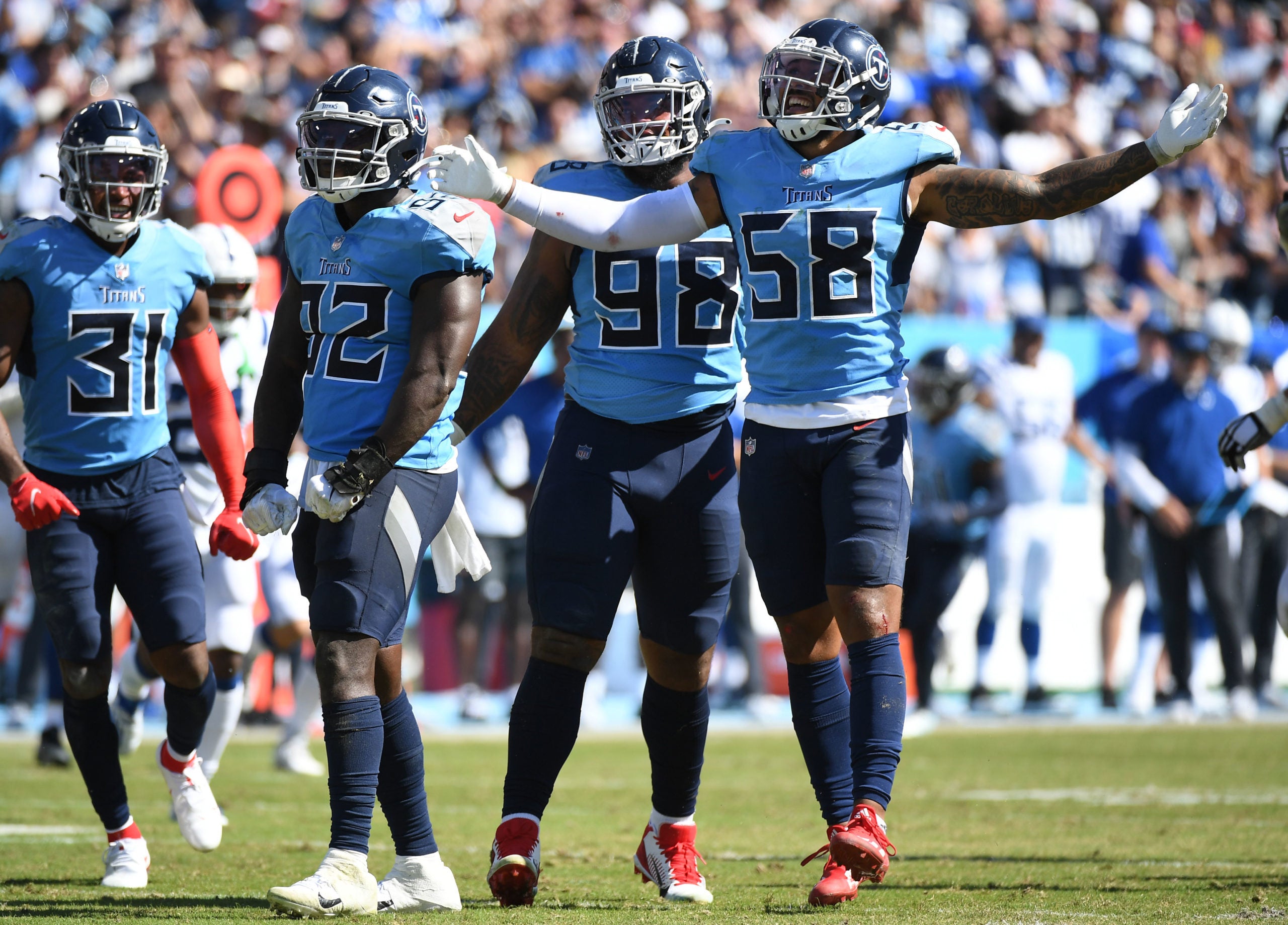 Sep 26, 2021; Nashville, Tennessee, USA; Tennessee Titans linebacker Ola Adeniyi (92) and Tennessee Titans linebacker Harold Landry (58) and Tennessee Titans defensive tackle Jeffery Simmons (98) celebrate after sacking Indianapolis Colts quarterback Carson Wentz (2) during the second half at Nissan Stadium. Mandatory Credit: Christopher Hanewinckel-USA TODAY Sports