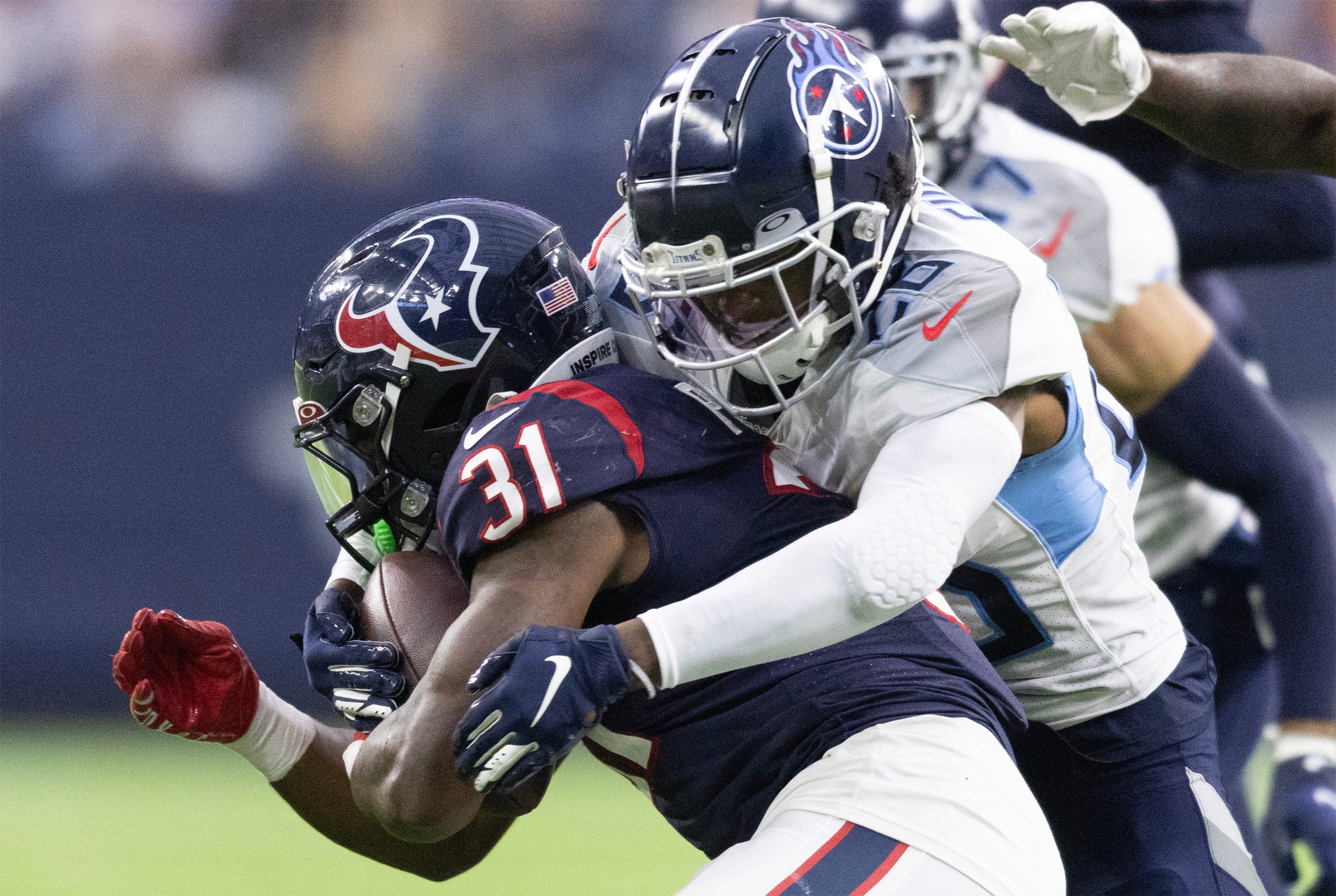 Oct 30, 2022; Houston, Texas, USA; Houston Texans running back Dameon Pierce (31) is tackled by Tennessee Titans cornerback Kristian Fulton (26) in the fourth quarter at NRG Stadium. Mandatory Credit: Thomas Shea-USA TODAY Sports