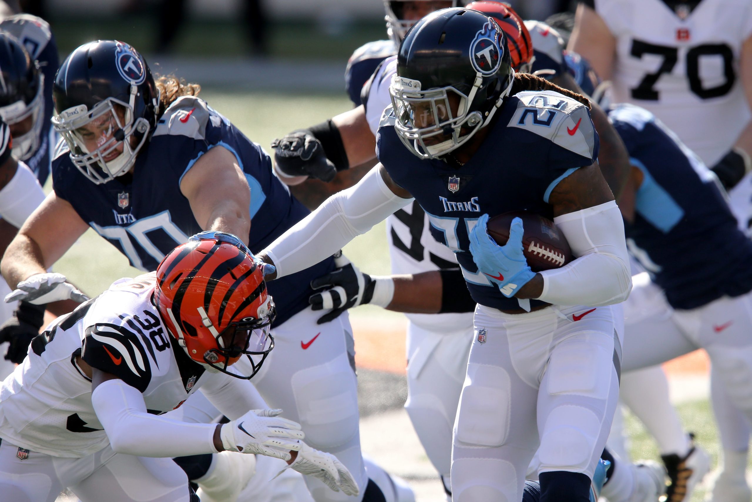 Tennessee Titans running back Derrick Henry (22) stuff arms Cincinnati Bengals cornerback LeShaun Sims (38) on a run during the first quarter of a Week 8 NFL football game, Sunday, Nov. 1, 2020, at Paul Brown Stadium in Cincinnati. Tennessee Titans At Cincinnati Bengals Nov 1