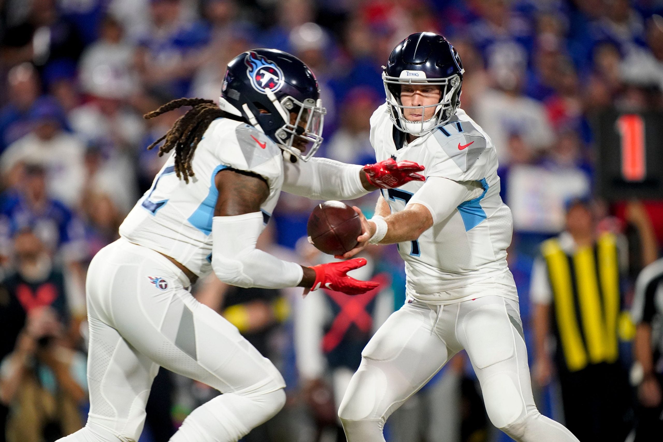 Tennessee Titans quarterback Ryan Tannehill (17) hands the ball to running back Derrick Henry (22) during the second quarter against the Buffalo Bills at Highmark Stadium Monday, Sept. 19, 2022, in Orchard Park, New York. Nfl Tennessee Titans At Buffalo Bills