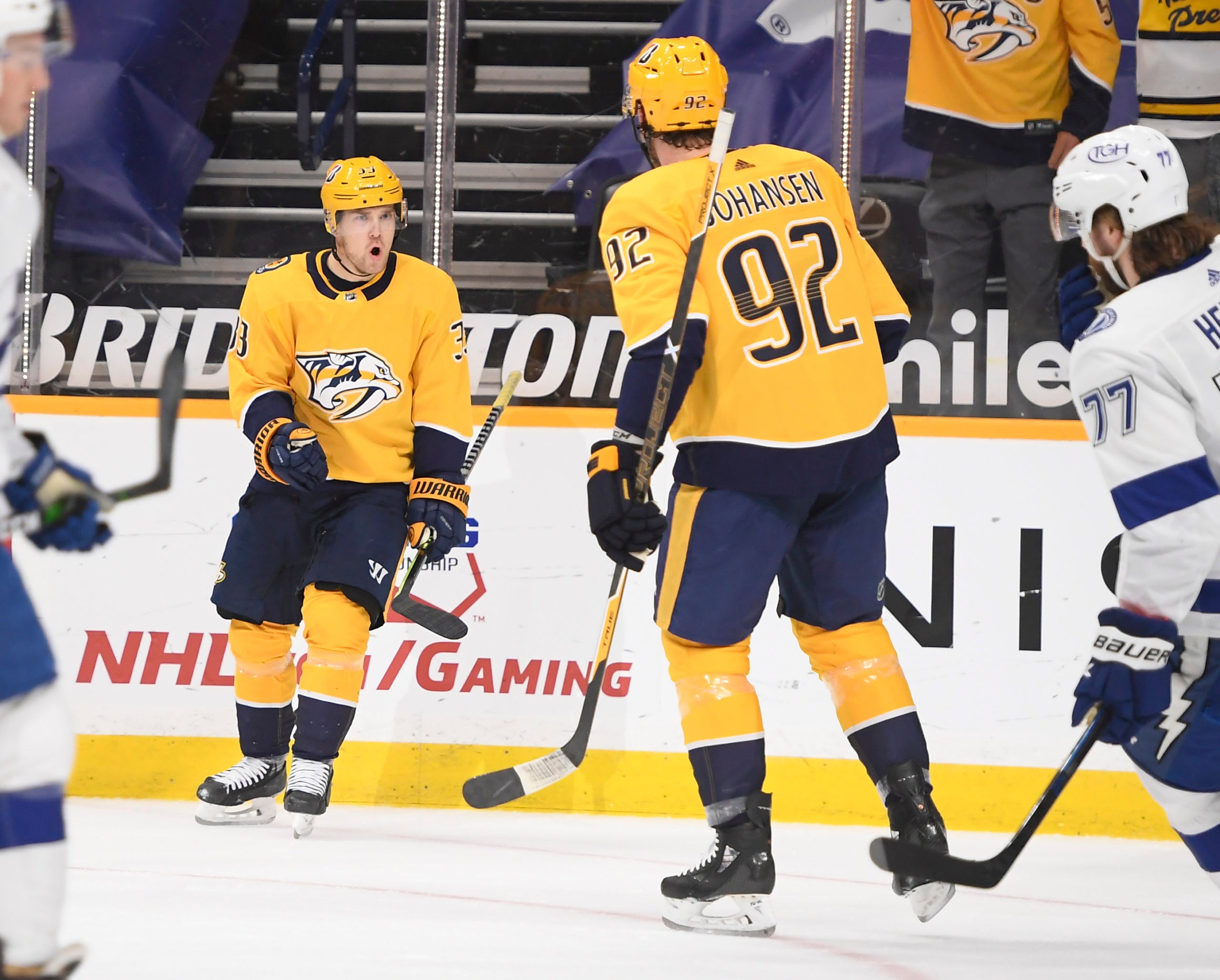 Apr 13, 2021; Nashville, Tennessee, USA;  Nashville Predators center Ryan Johansen (92) celebrates the goal of right wing Viktor Arvidsson (33) against the Tampa Bay Lightning during the first period at Bridgestone Arena. Mandatory Credit: Steve Roberts-USA TODAY Sports
