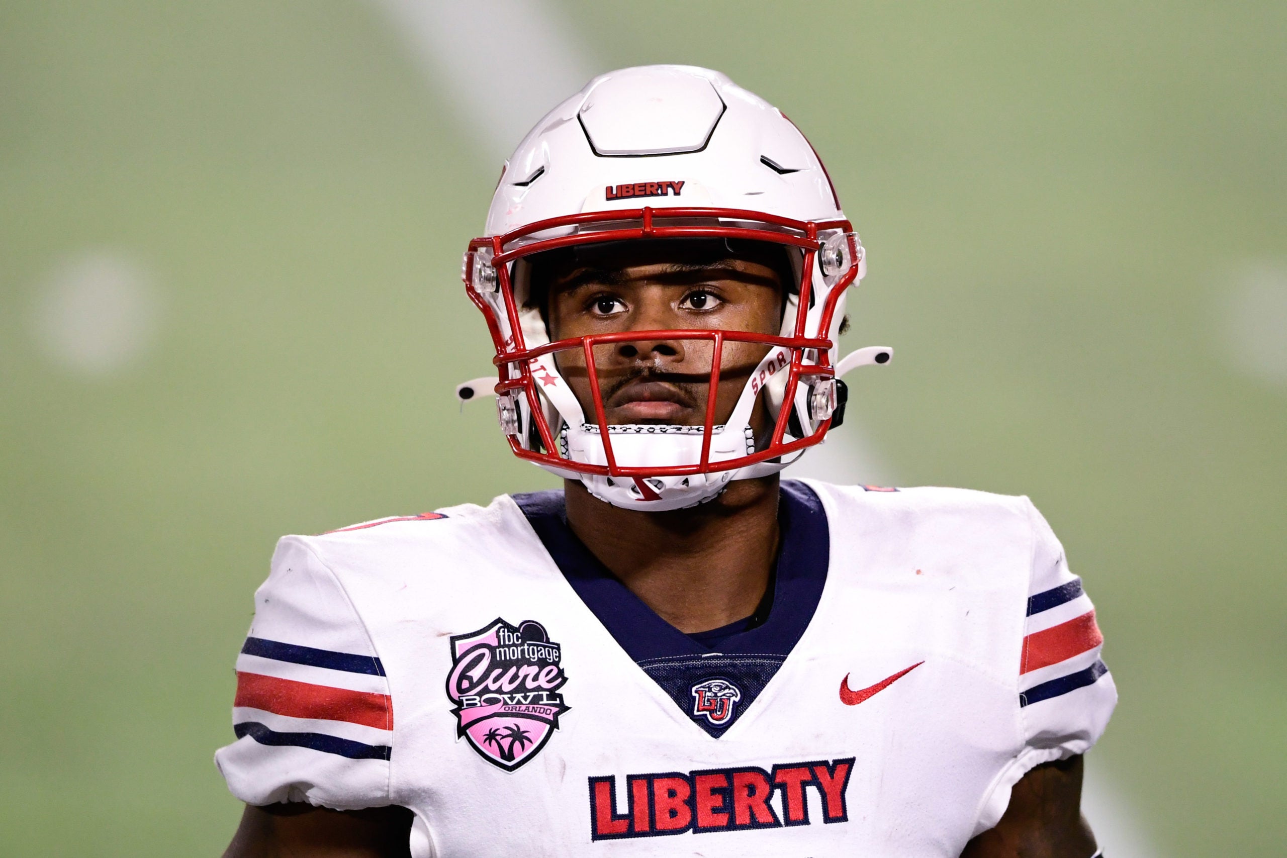Dec 26, 2020; Orlando, FL, USA; Liberty Flames quarterback Malik Willis (7) looks on during the second half against the Coastal Carolina Chanticleers during the Cure Bowl at Camping World Stadium. Mandatory Credit: Douglas DeFelice-USA TODAY Sports