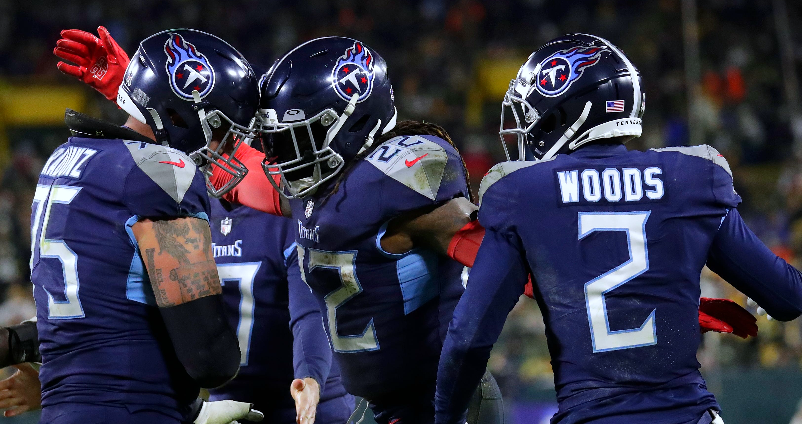 Tennessee Titans running back Derrick Henry (22) celebrates scoring a touchdown with offensive tackle Dillon Radunz (75) and wide receiver Robert Woods (2) against the Green Bay Packers during their game Thursday, Nov. 17, at Lambeau Field in Green Bay. Mjs Apc Packvstitans 1117220963djp