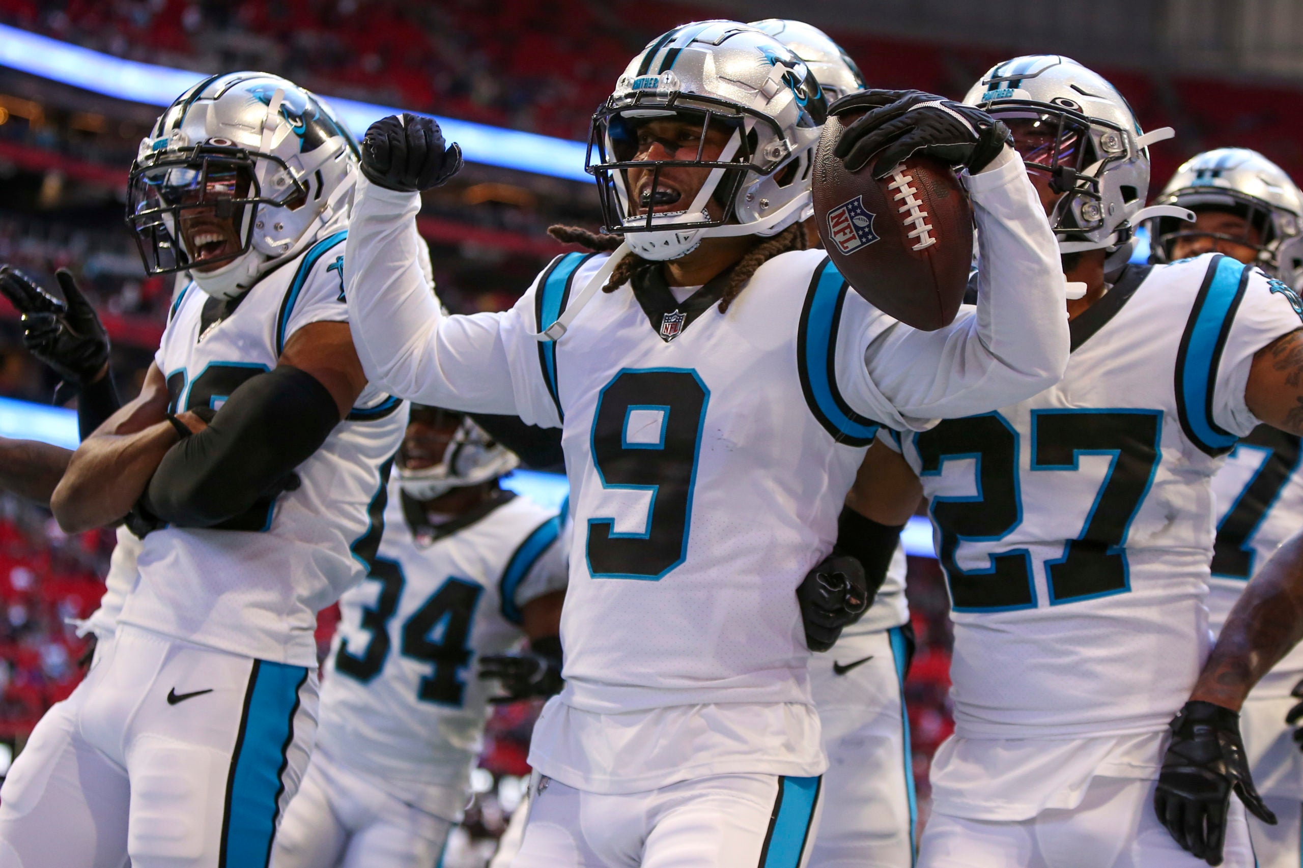 Oct 31, 2021; Atlanta, Georgia, USA; Carolina Panthers cornerback Stephon Gilmore (9) celebrates after an interception with teammates against the Atlanta Falcons in the fourth quarter at Mercedes-Benz Stadium. Mandatory Credit: Brett Davis-USA TODAY Sports