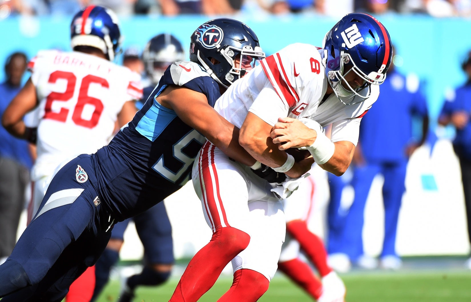 Sep 11, 2022; Nashville, Tennessee, USA; New York Giants quarterback Daniel Jones (8) is sacked by Tennessee Titans linebacker Rashad Weaver (99) during the first half at Nissan Stadium. Mandatory Credit: Christopher Hanewinckel-USA TODAY Sports