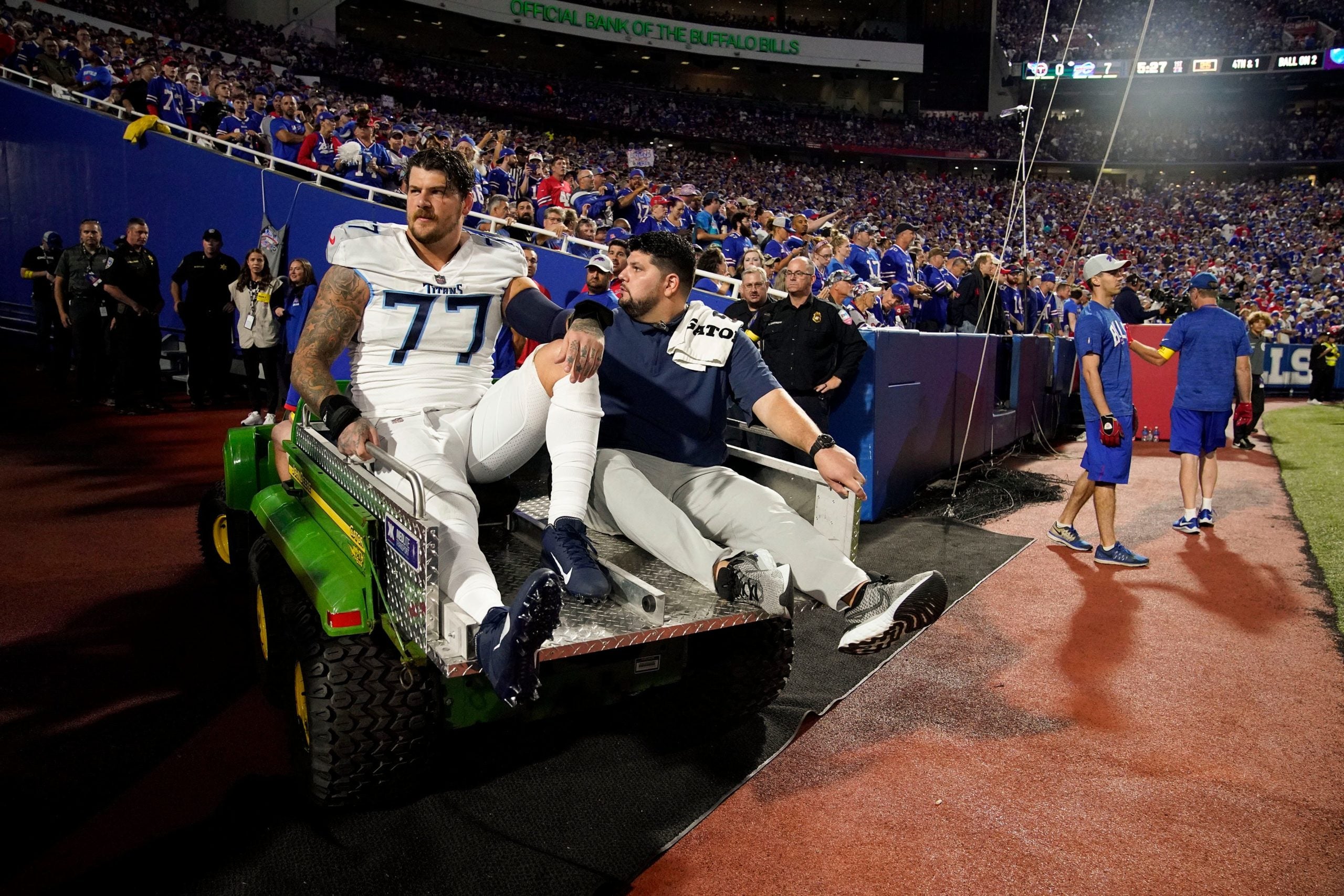 Tennessee Titans offensive tackle Taylor Lewan (77) is helped from the field after getting hurt during the first quarter against the Buffalo Bills at Highmark Stadium Monday, Sept. 19, 2022, in Orchard Park, New York. Nfl Tennessee Titans At Buffalo Bills