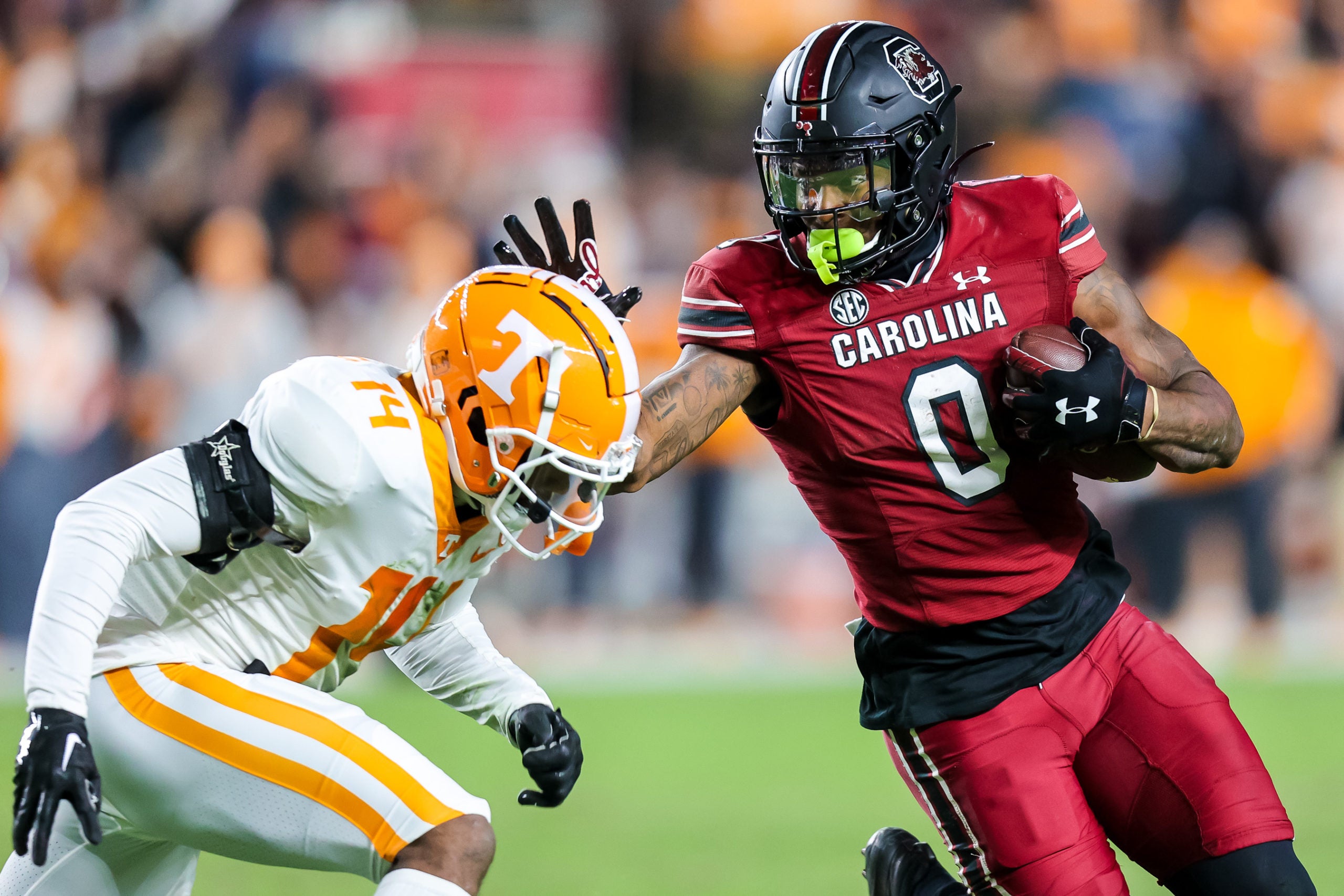 Nov 19, 2022; Columbia, South Carolina, USA; South Carolina Gamecocks tight end Jaheim Bell (0) stiff-arms Tennessee Volunteers defensive back Christian Charles (14) in the second half at Williams-Brice Stadium. Mandatory Credit: Jeff Blake-USA TODAY Sports