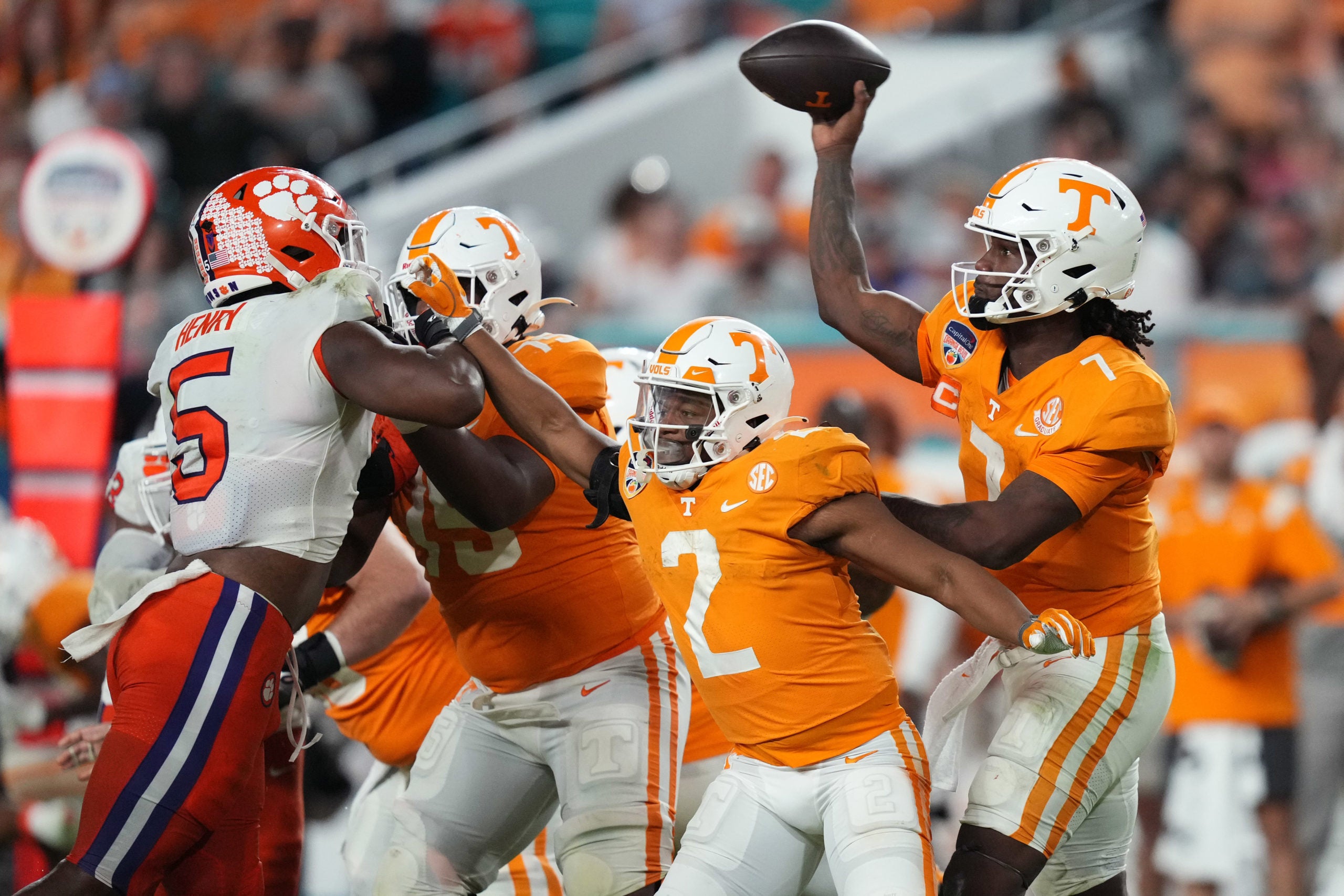 Dec 30, 2022; Miami Gardens, FL, USA; Tennessee Volunteers quarterback Joe Milton III (7) throws a pass over Clemson Tigers defensive end K.J. Henry (5) during the second half of the 2022 Orange Bowl at Hard Rock Stadium. Mandatory Credit: Jasen Vinlove-USA TODAY Sports