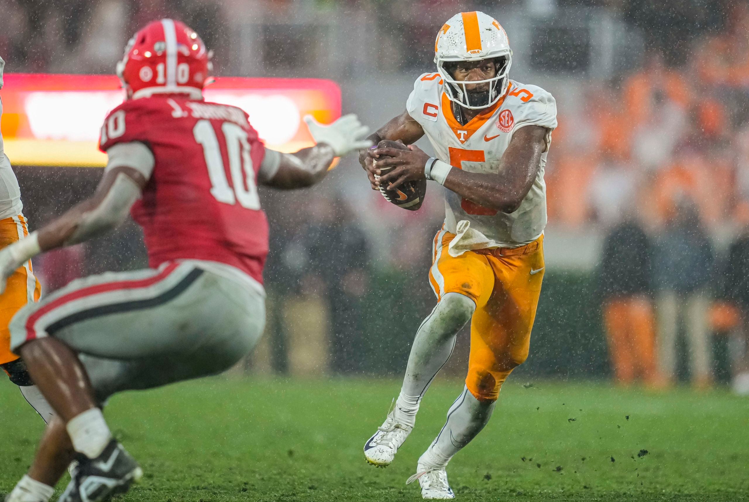 Nov 5, 2022; Athens, Georgia, USA; Tennessee Volunteers quarterback Hendon Hooker (5) runs against Tennessee Volunteers linebacker Juwan Mitchell (10) during the second half at Sanford Stadium. Mandatory Credit: Dale Zanine-USA TODAY Sports