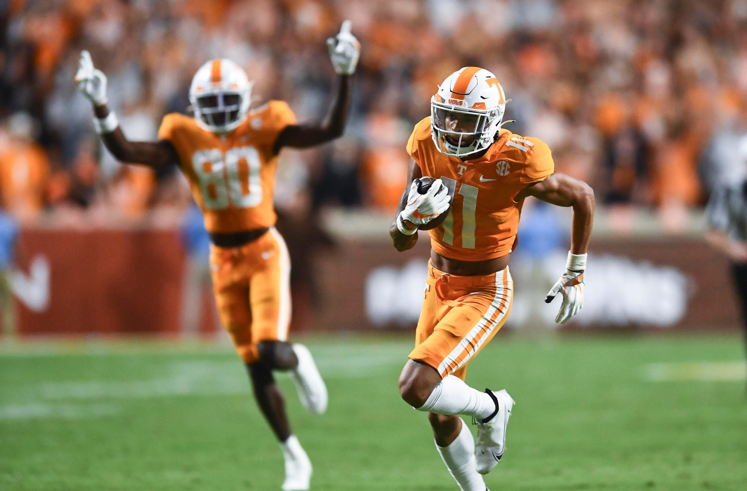 Tennessee wide receiver Jalin Hyatt (11) returns the ball 41 yards for a touchdown against Akron during an NCAA college football game against on Saturday, September 17, 2022 in Knoxville, Tenn. Cheering him on at left is Tennessee wide receiver Ramel Keyton (80). Utvakron0917