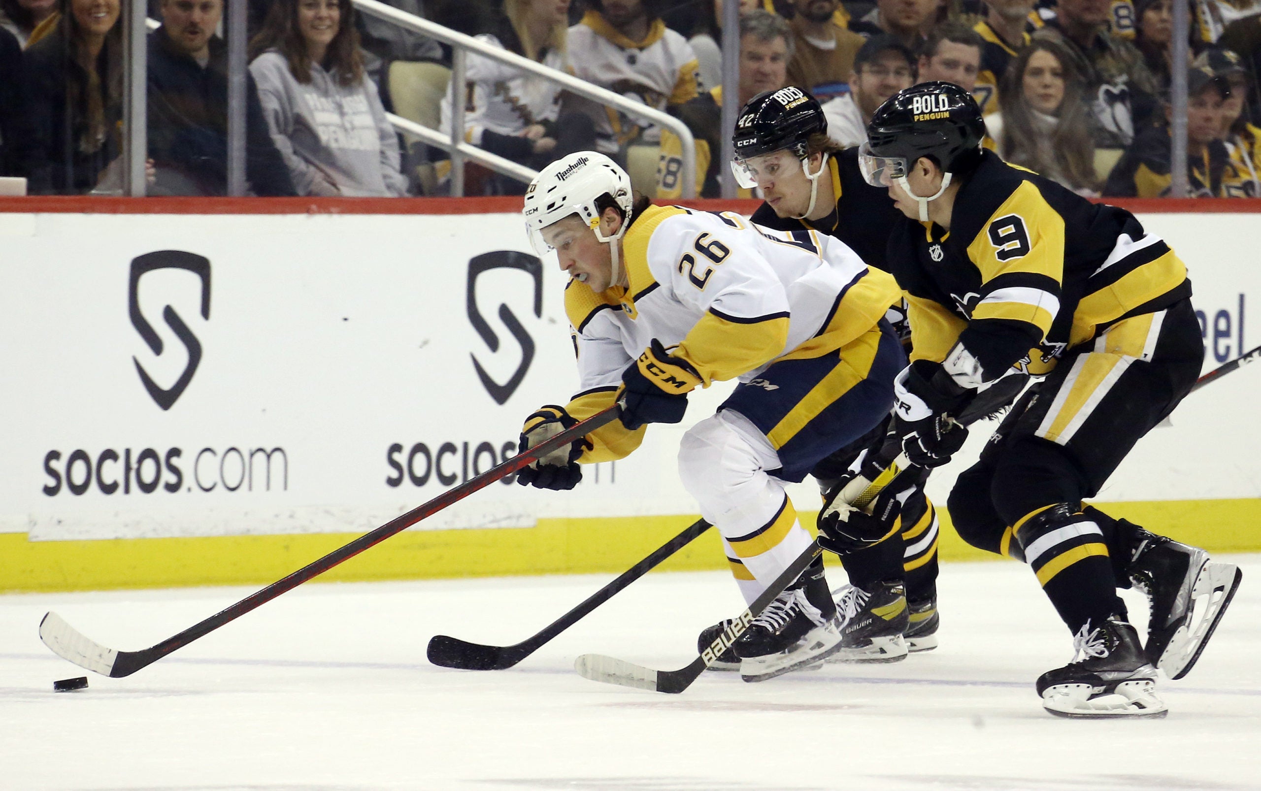 Evan Rodrigues chases Nashville Predators Philip Tomasino for control of the puck.