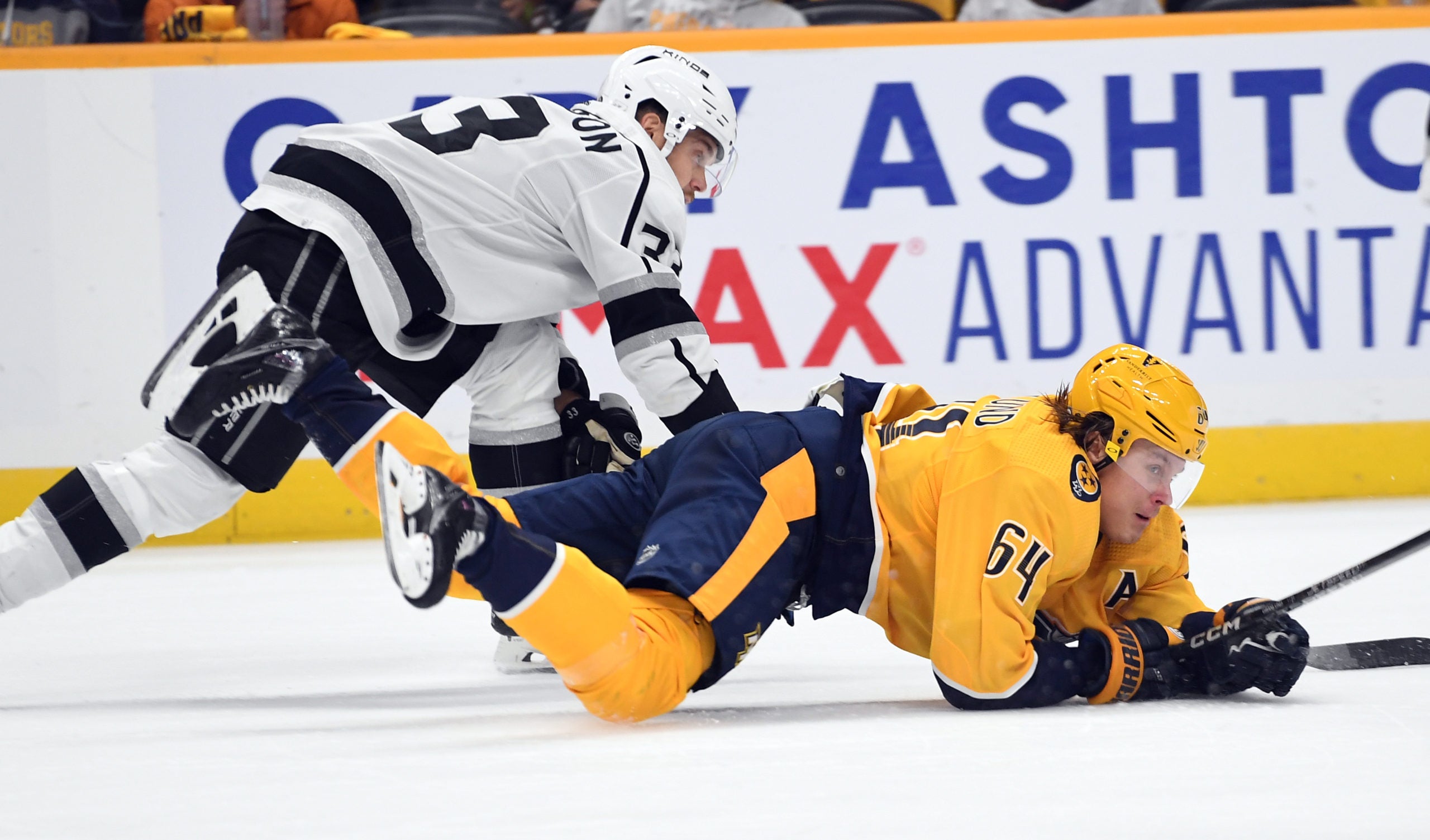 Oct 18, 2022; Nashville, Tennessee, USA; Nashville Predators center Mikael Granlund (64) falls after being tripped by Los Angeles Kings left wing Viktor Arvidsson (33) during the third period at Bridgestone Arena. Mandatory Credit: Christopher Hanewinckel-USA TODAY Sports