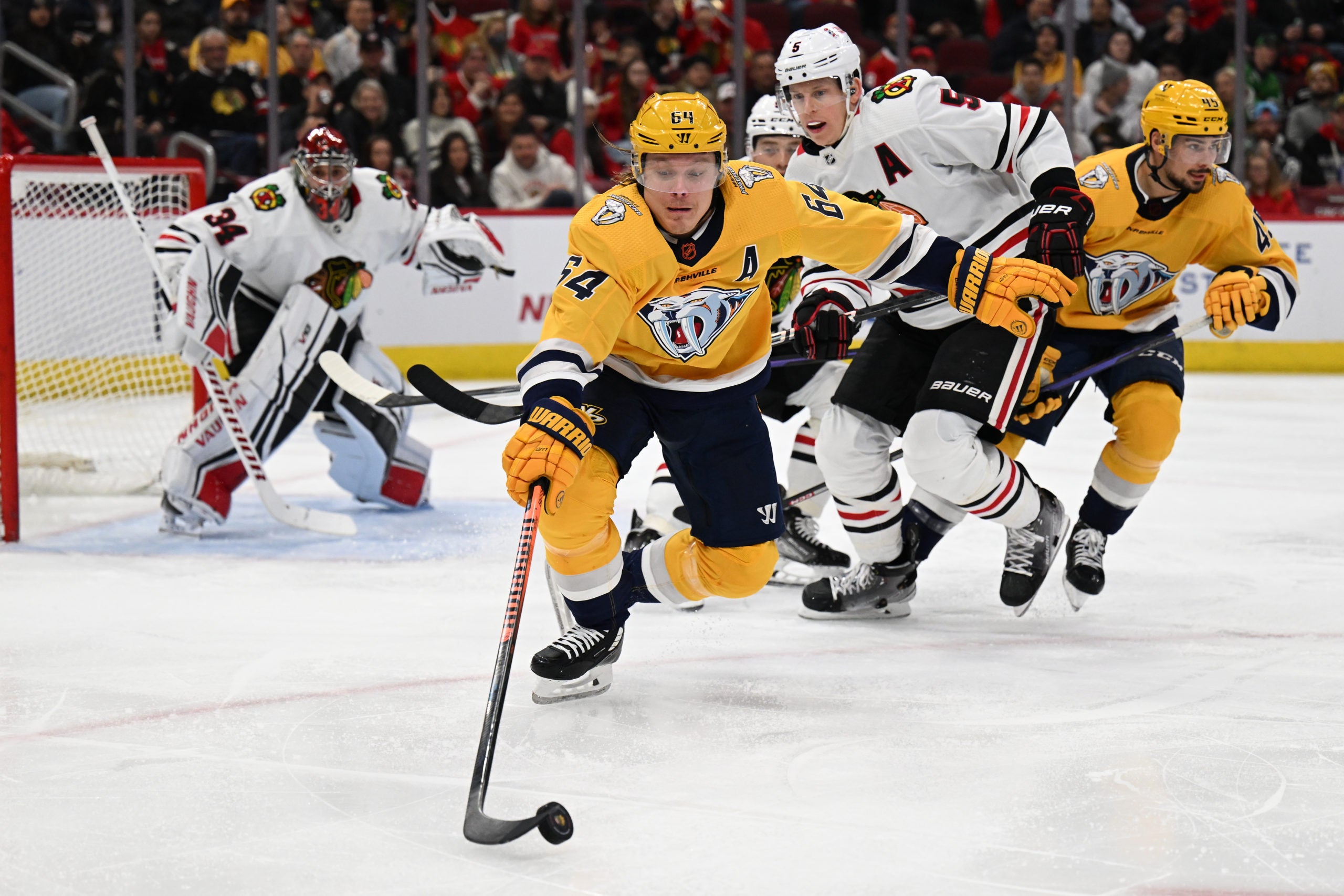 Nashville Predators forward Mikael Granlund reaches for a puck.