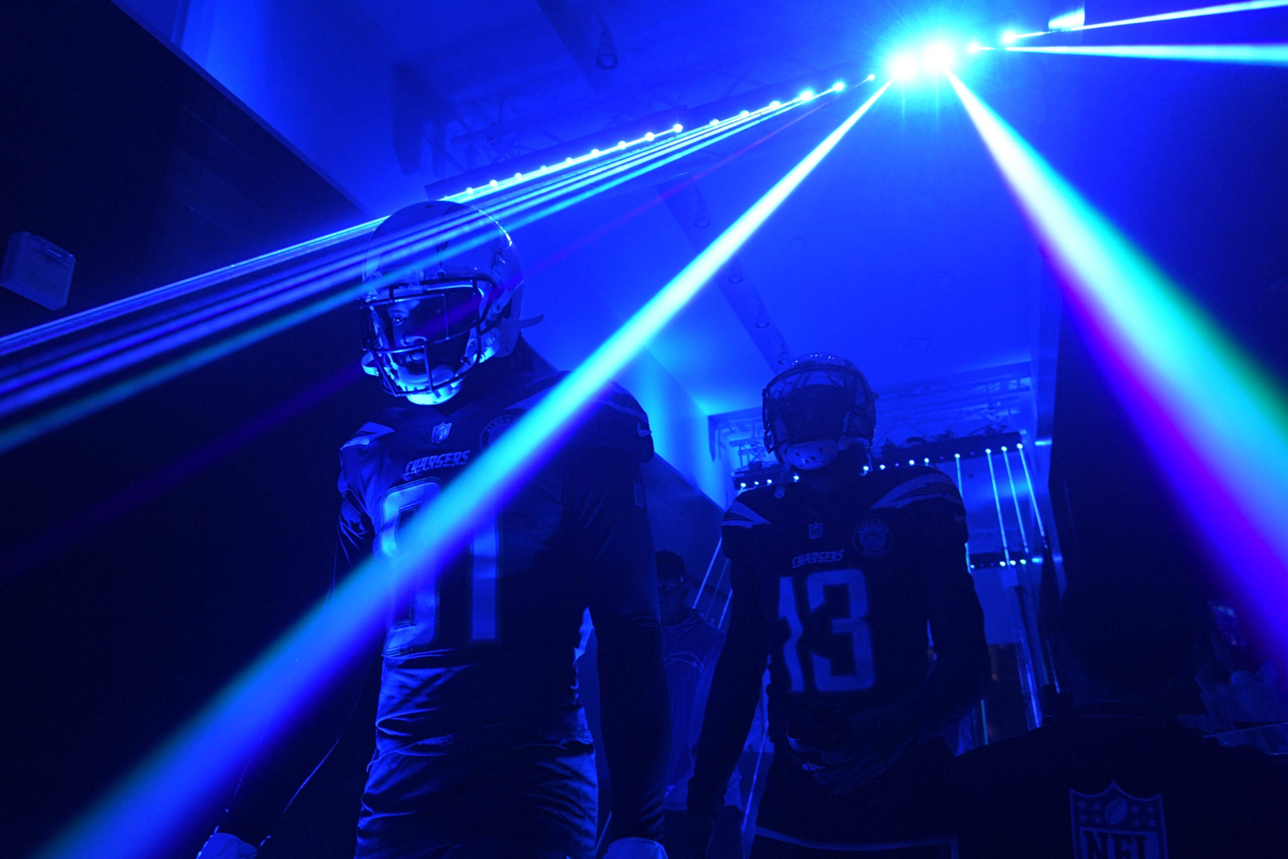 Dec 22, 2018; Carson, CA, USA; Los Angeles Chargers receivers Mike Williams (81) and Keenan Allen (13) enter the field through lasers before the game against the Balitmore Ravens at StubHub Center. Mandatory Credit: Kirby Lee-USA TODAY Sports
