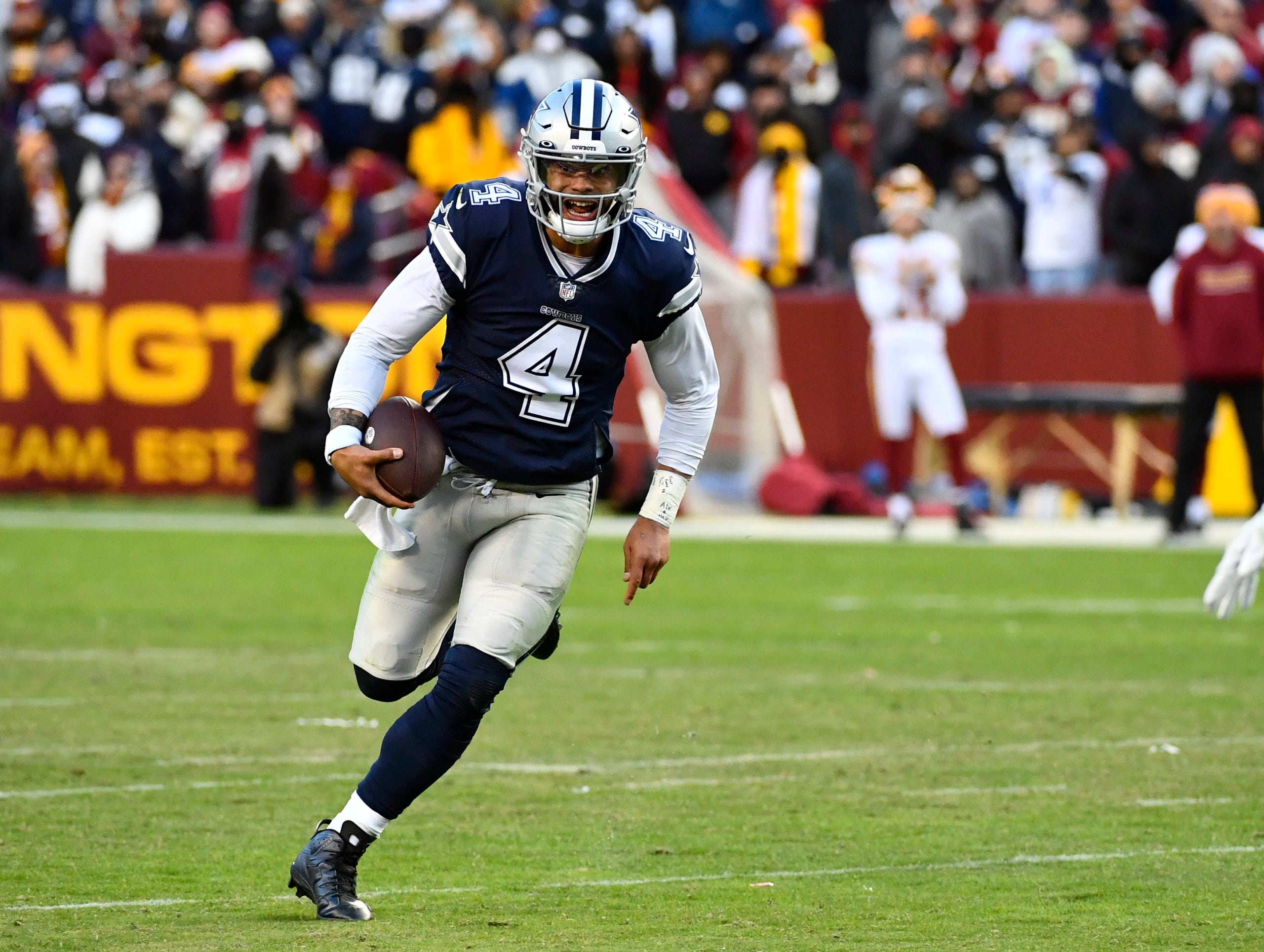 Dec 12, 2021; Landover, Maryland, USA; Dallas Cowboys quarterback Dak Prescott (4) carries the ball against the Washington Football Team during the second half at FedExField. Mandatory Credit: Brad Mills-USA TODAY Sports