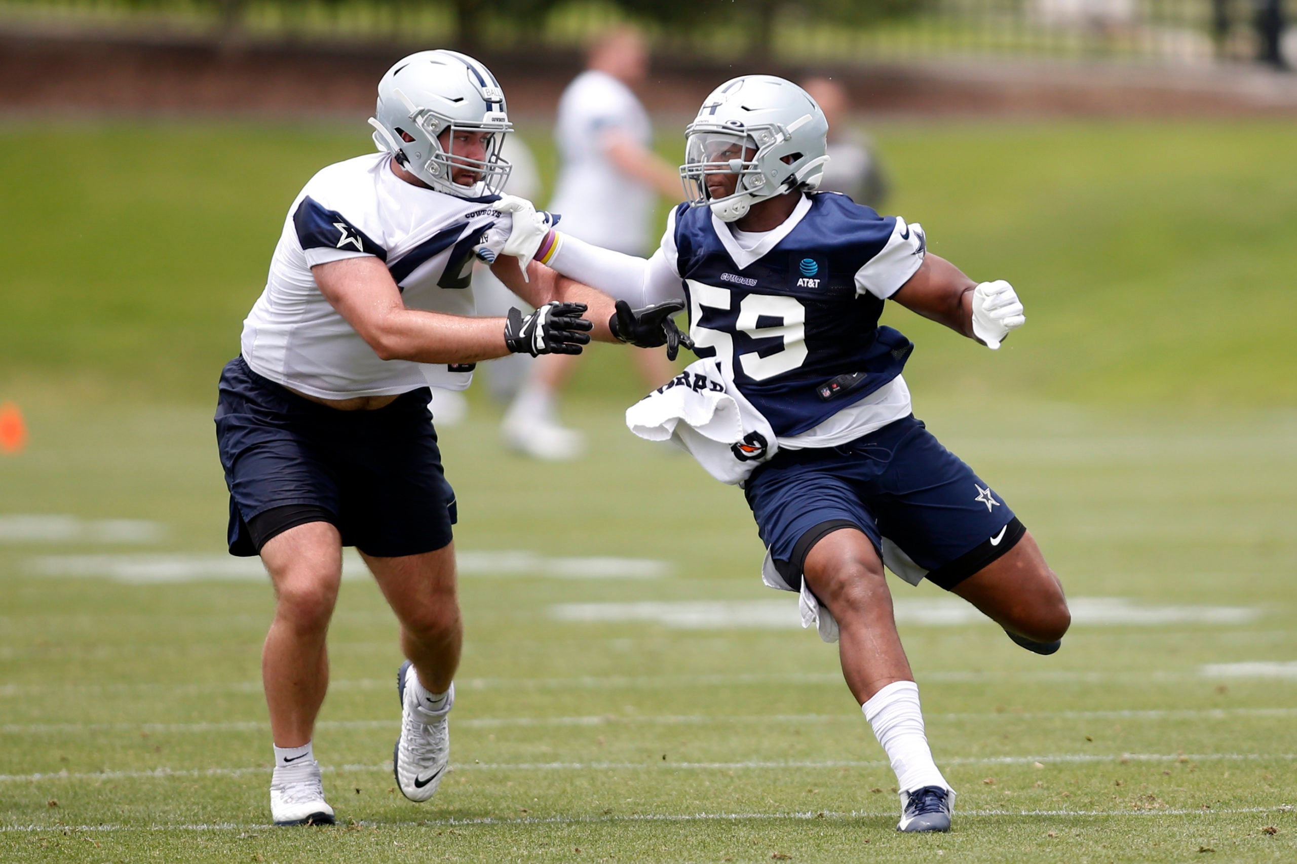 Jun 3, 2021; Frisco, TX, USA; Dallas Cowboys defensive end Chauncey Golston (59) goes through a drill against tackle Josh Ball (76) during voluntary Organized Team Activities at the Star Training Facility in Frisco, Texas. Mandatory Credit: Tim Heitman-USA TODAY Sports