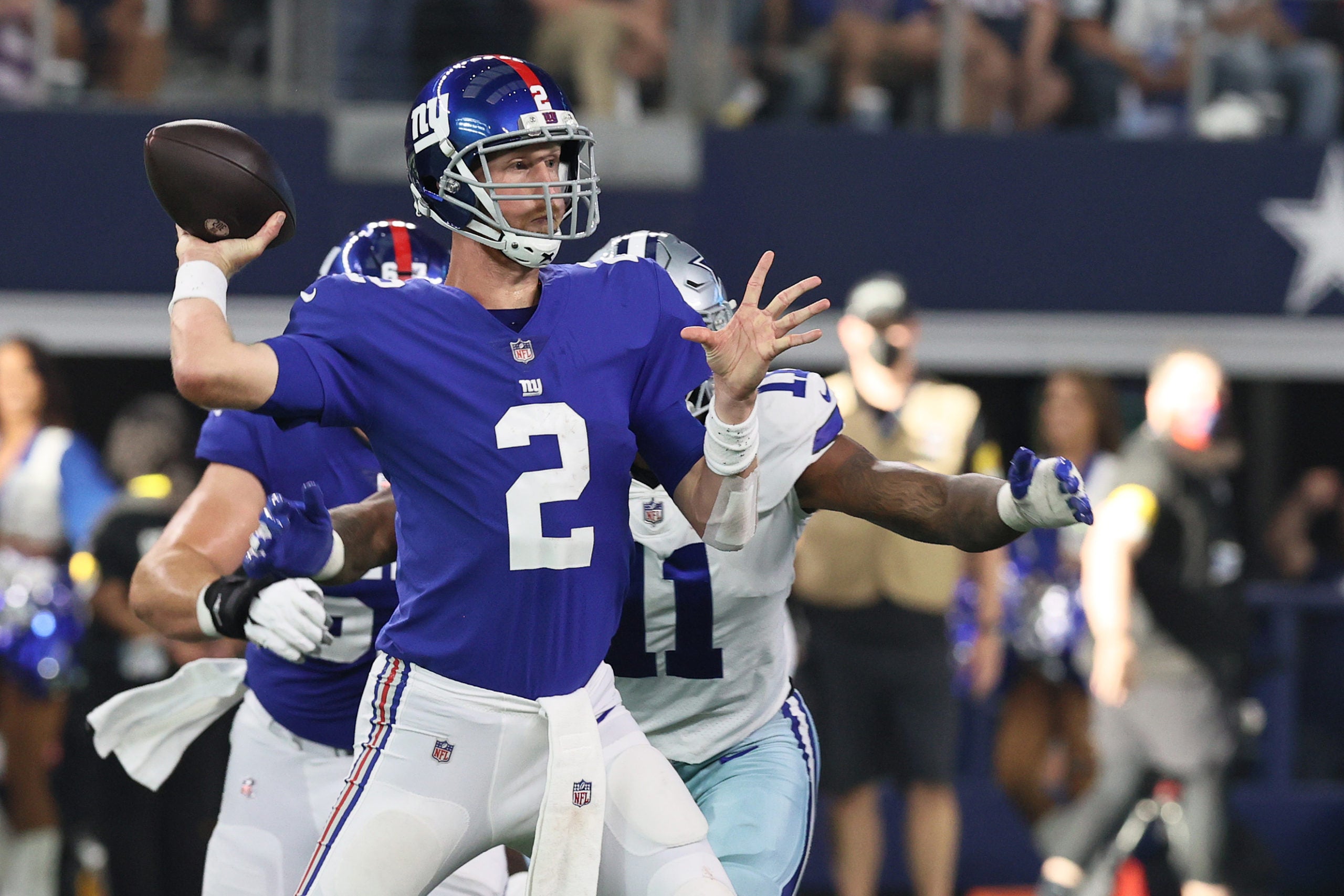 Oct 10, 2021; Arlington, Texas, USA; New York Giants quarterback Mike Glennon (2) throws the ball as Dallas Cowboys outside linebacker Micah Parsons (11) defends in the fourth quarter at AT&T Stadium. Mandatory Credit: Matthew Emmons-USA TODAY Sports