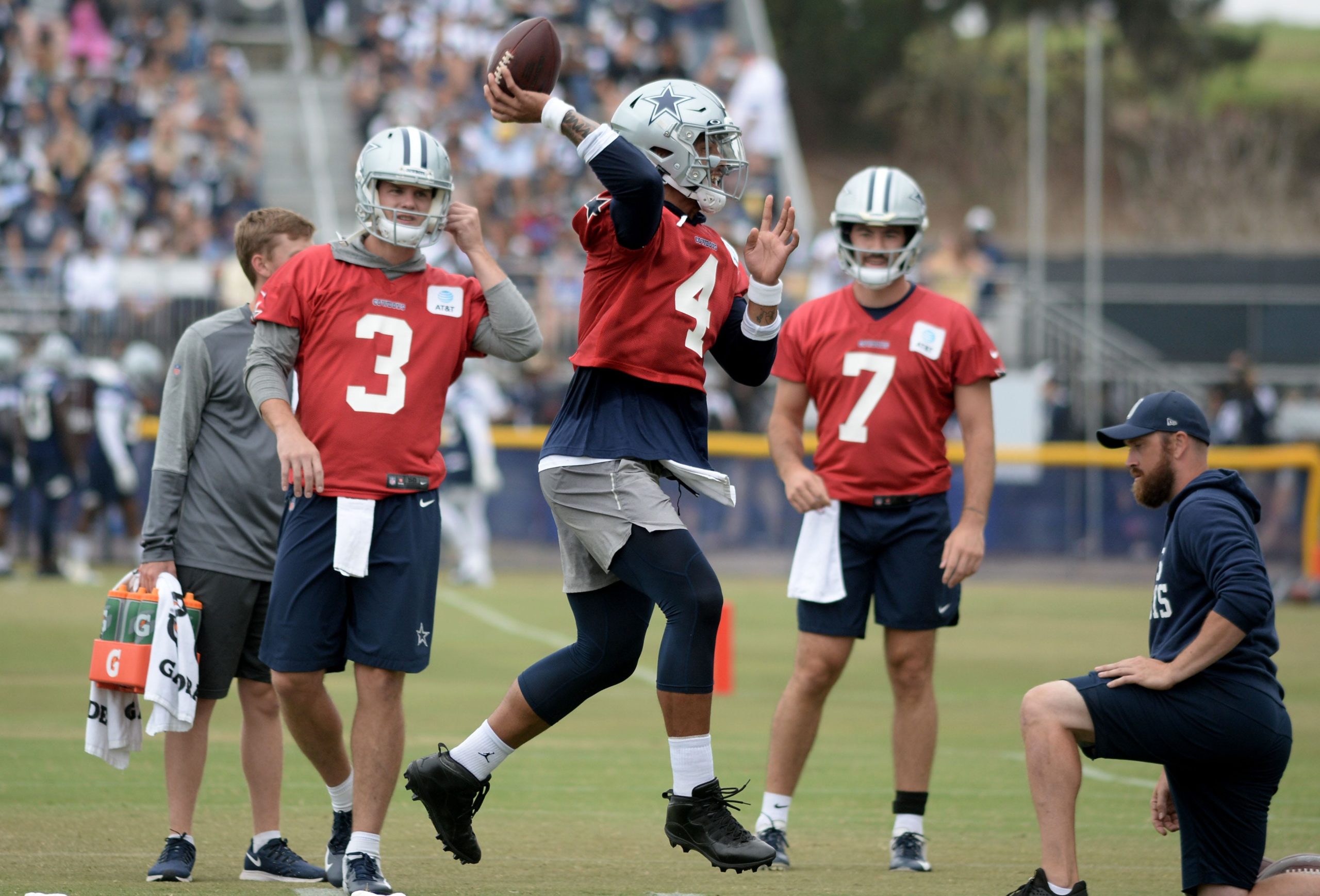 Quarterback Dak Prescott jumps in the air to throw a pass during the Dallas Cowboys' first full day of training camp at the River Ridge Playing Fields in Oxnard on Saturday, July 24, 2021. Cowboys Training Camp 26