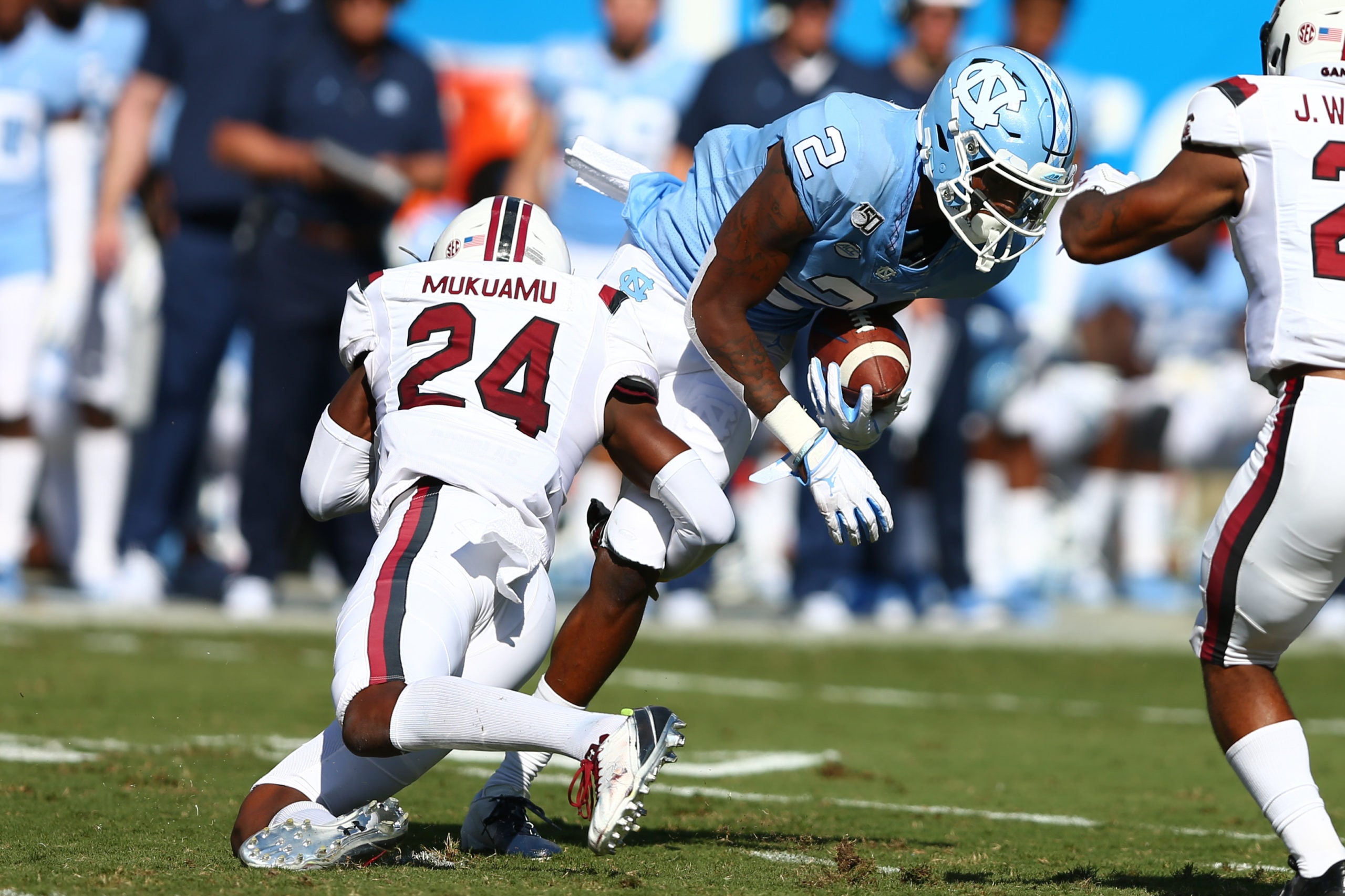 Aug 31, 2019; Charlotte, NC, USA; North Carolina Tar Heels wide receiver Dyami Brown (2) gets tackled by South Carolina Gamecocks defensive back Israel Mukuamu (24) during the first half at Bank of America Stadium. Mandatory Credit: Jeremy Brevard-USA TODAY Sports