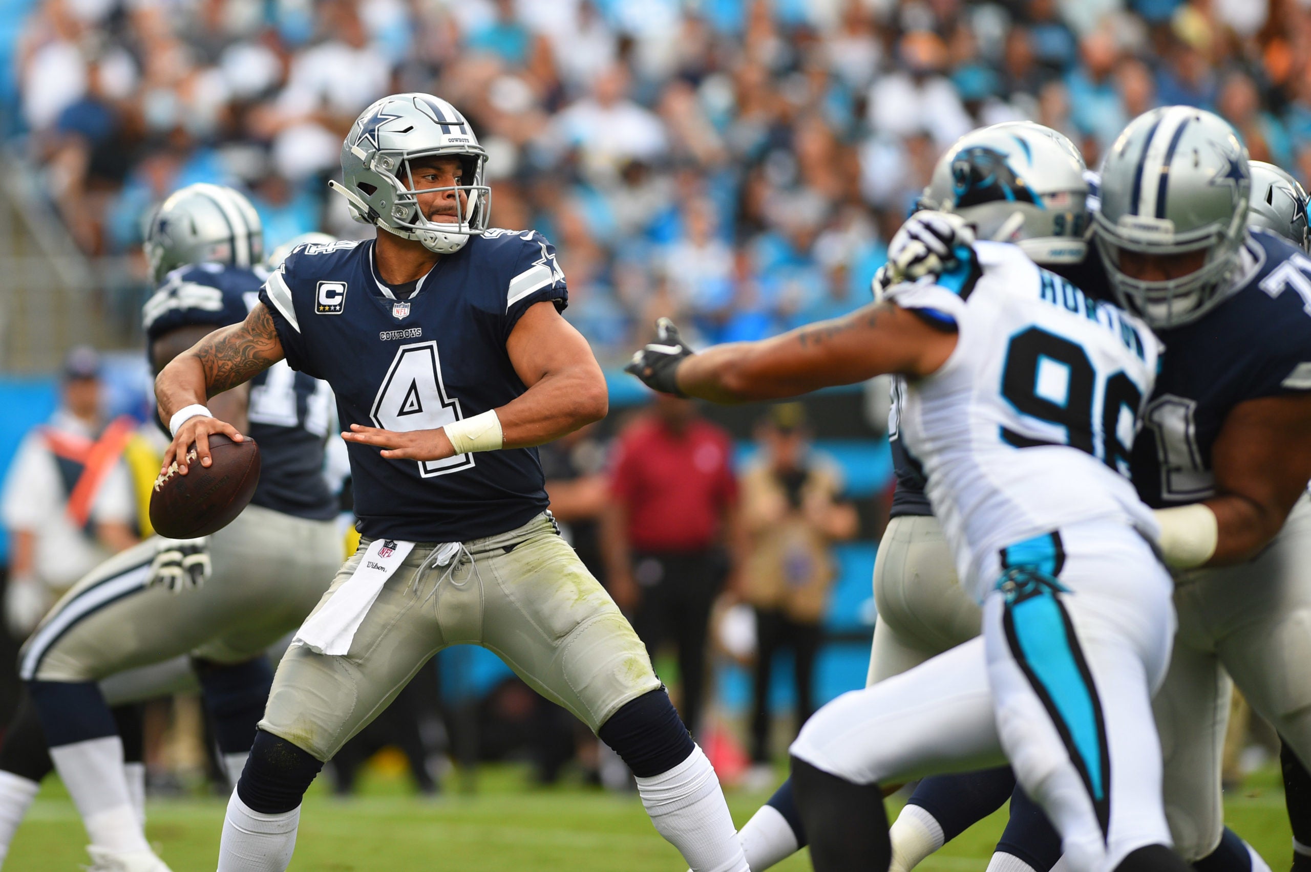 Sep 9, 2018; Charlotte, NC, USA; Dallas Cowboys quarterback Dak Prescott (4) looks to pass as Carolina Panthers defensive end Wes Horton (96) pressures in the second quarter at Bank of America Stadium. Mandatory Credit: Bob Donnan-USA TODAY Sports