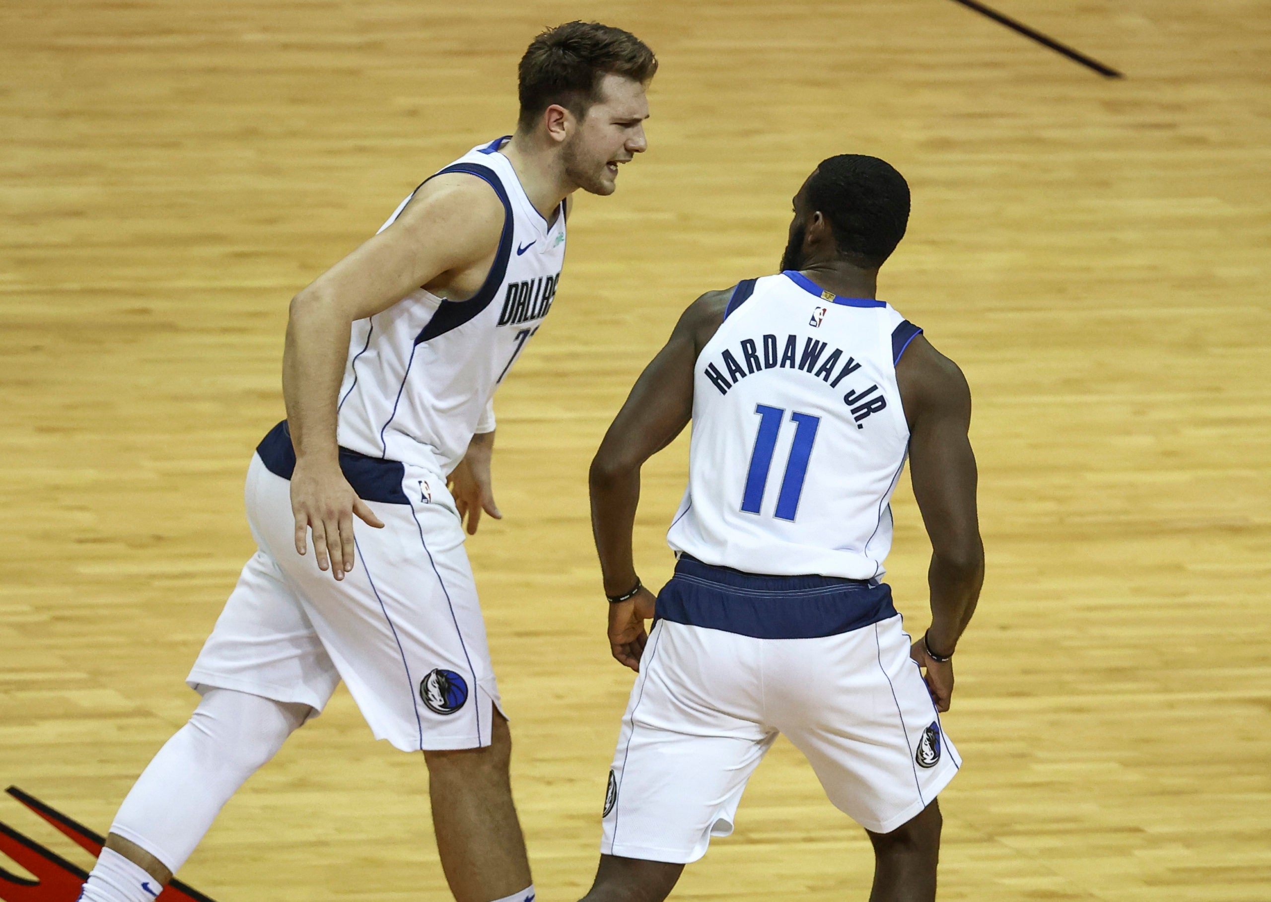 Jan 4, 2021; Houston, Texas, USA; Dallas Mavericks guard Luka Doncic (77) and guard Tim Hardaway Jr. (11) react after a play against the Houston Rockets during the fourth quarter at Toyota Center. Mandatory Credit: Troy Taormina-USA TODAY Sports