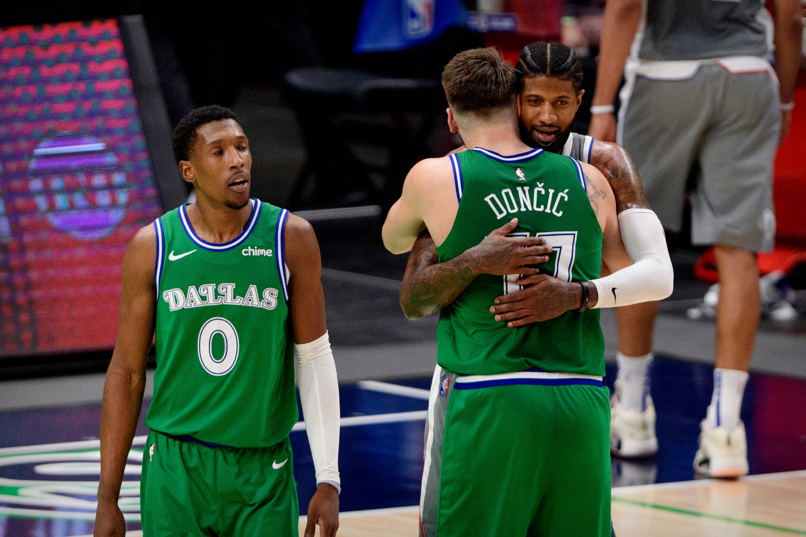 Mar 17, 2021; Dallas, Texas, USA; Dallas Mavericks guard Luka Doncic (77) hugs LA Clippers guard Paul George (13) after the game at the American Airlines Center. Mandatory Credit: Jerome Miron-USA TODAY Sports