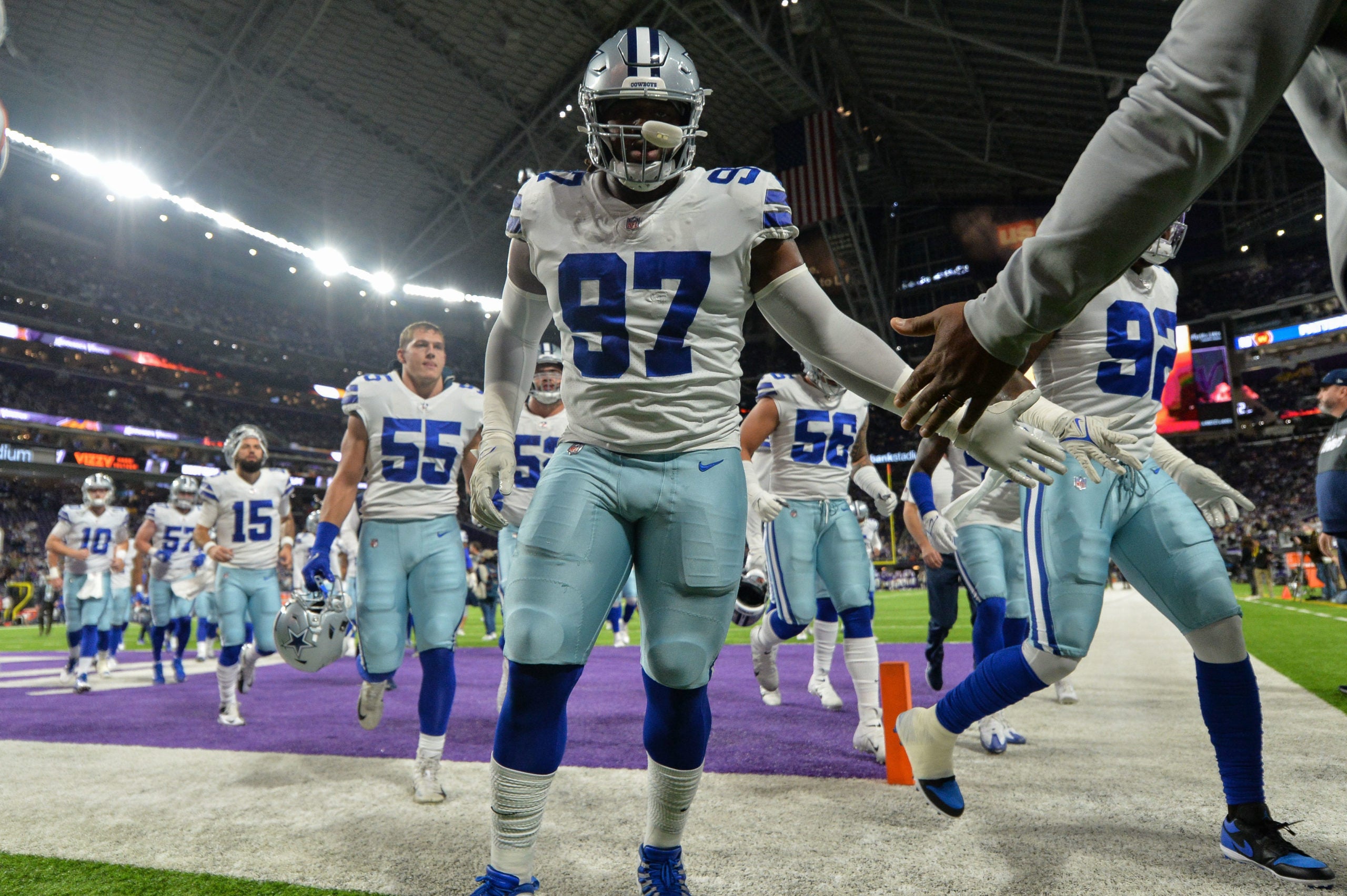 Oct 31, 2021; Minneapolis, Minnesota, USA; Dallas Cowboys defensive tackle Osa Odighizuwa (97) and outside linebacker Leighton Vander Esch (55) and teammates head for the locker room before the game against the Minnesota Vikings at U.S. Bank Stadium. Mandatory Credit: Jeffrey Becker-USA TODAY Sports